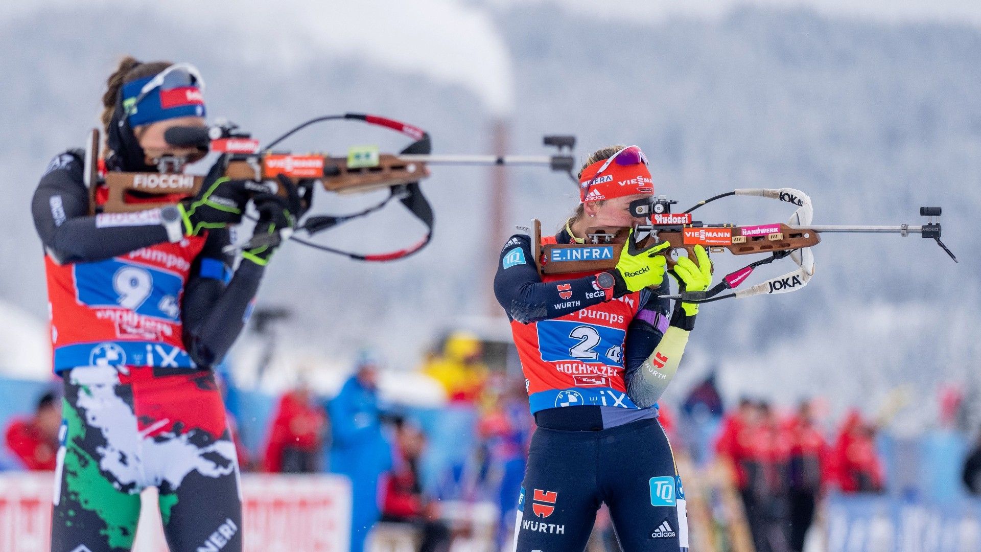 Italy's Lisa Vittozzi (L) and Germany's Denise Herrmann compete during the women's 4x6 relay competition