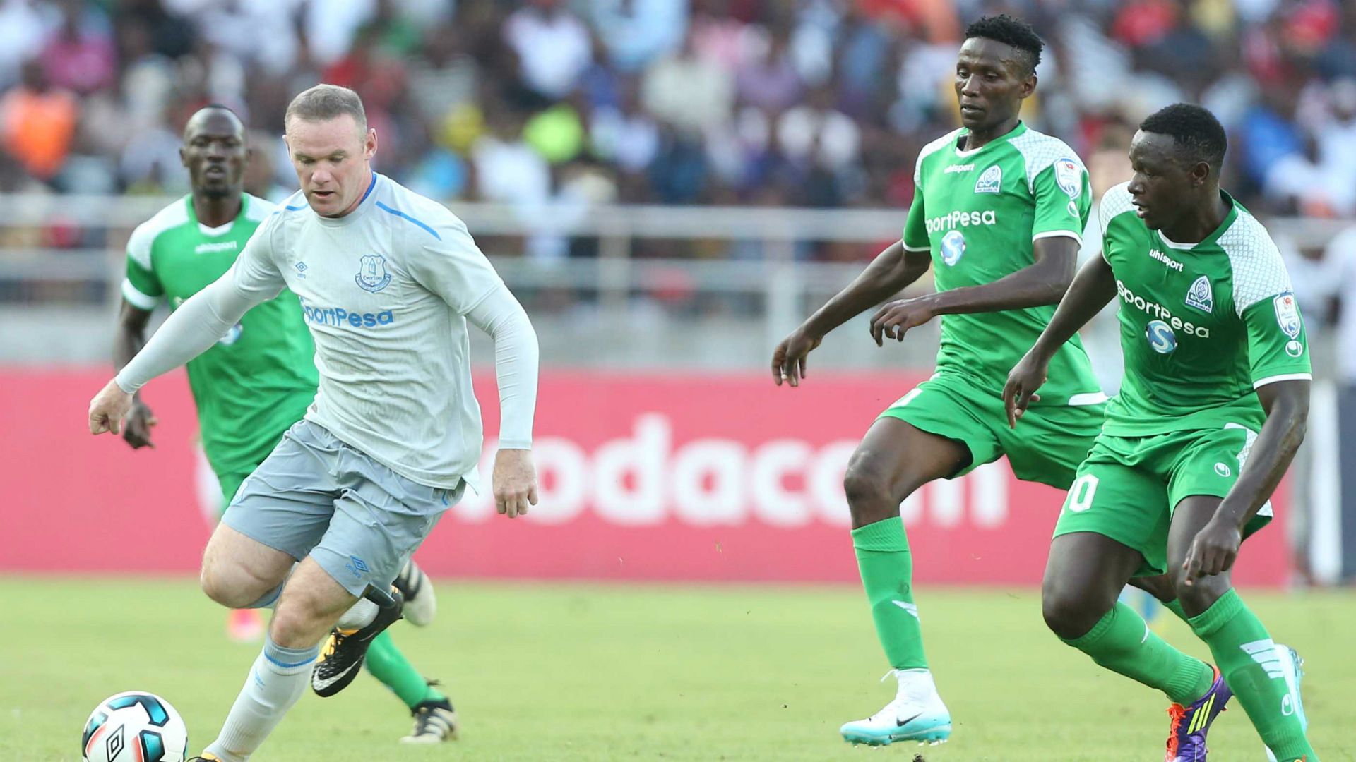 Wayne Rooney challenge Godfrey Walusimbi (L) Kenneth Muguna and Ernest Wendo
