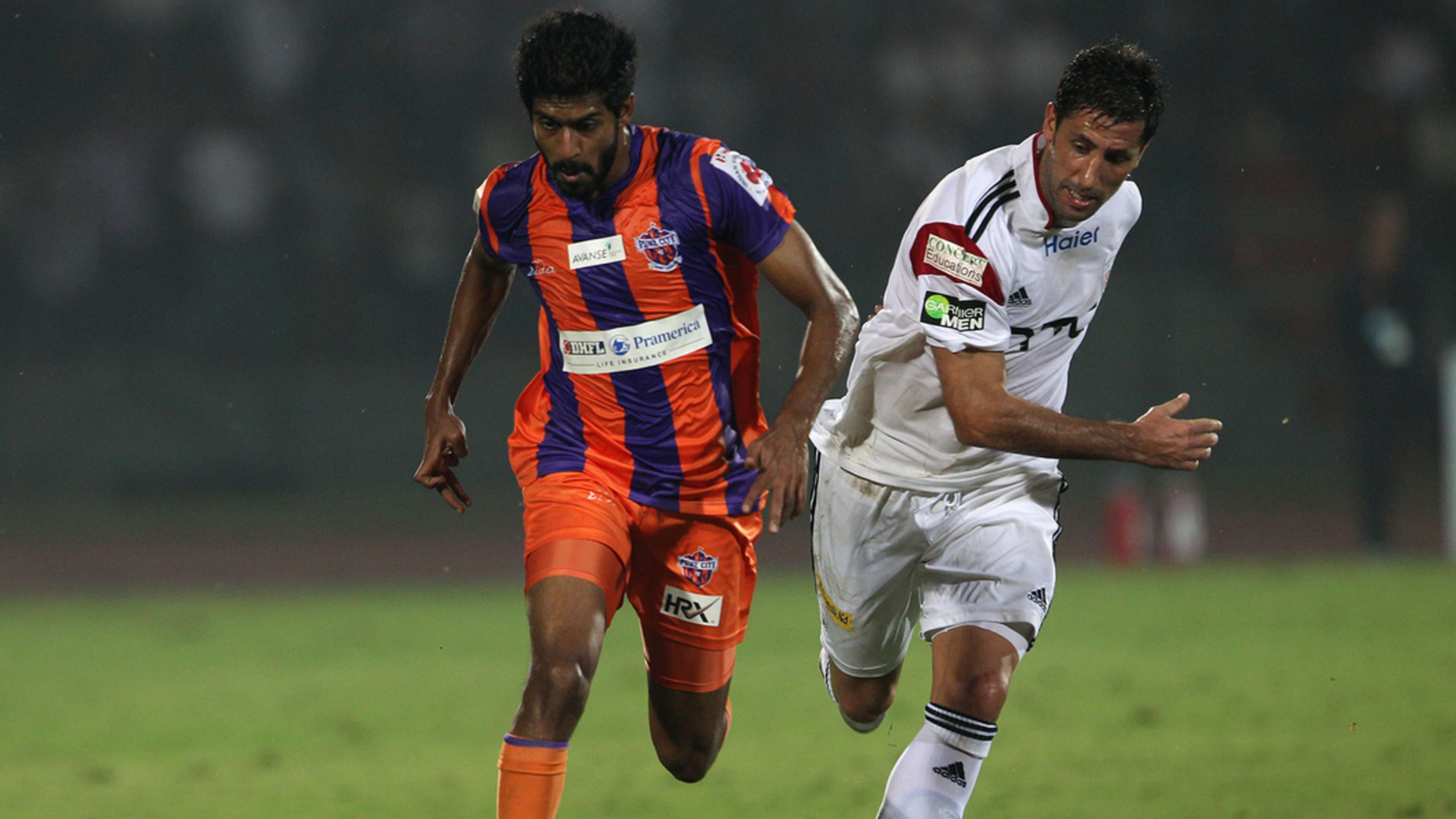 Ashutosh Mehta of FC Pune City and Joan Capdevila of NorthEast United FC in action during ISL match