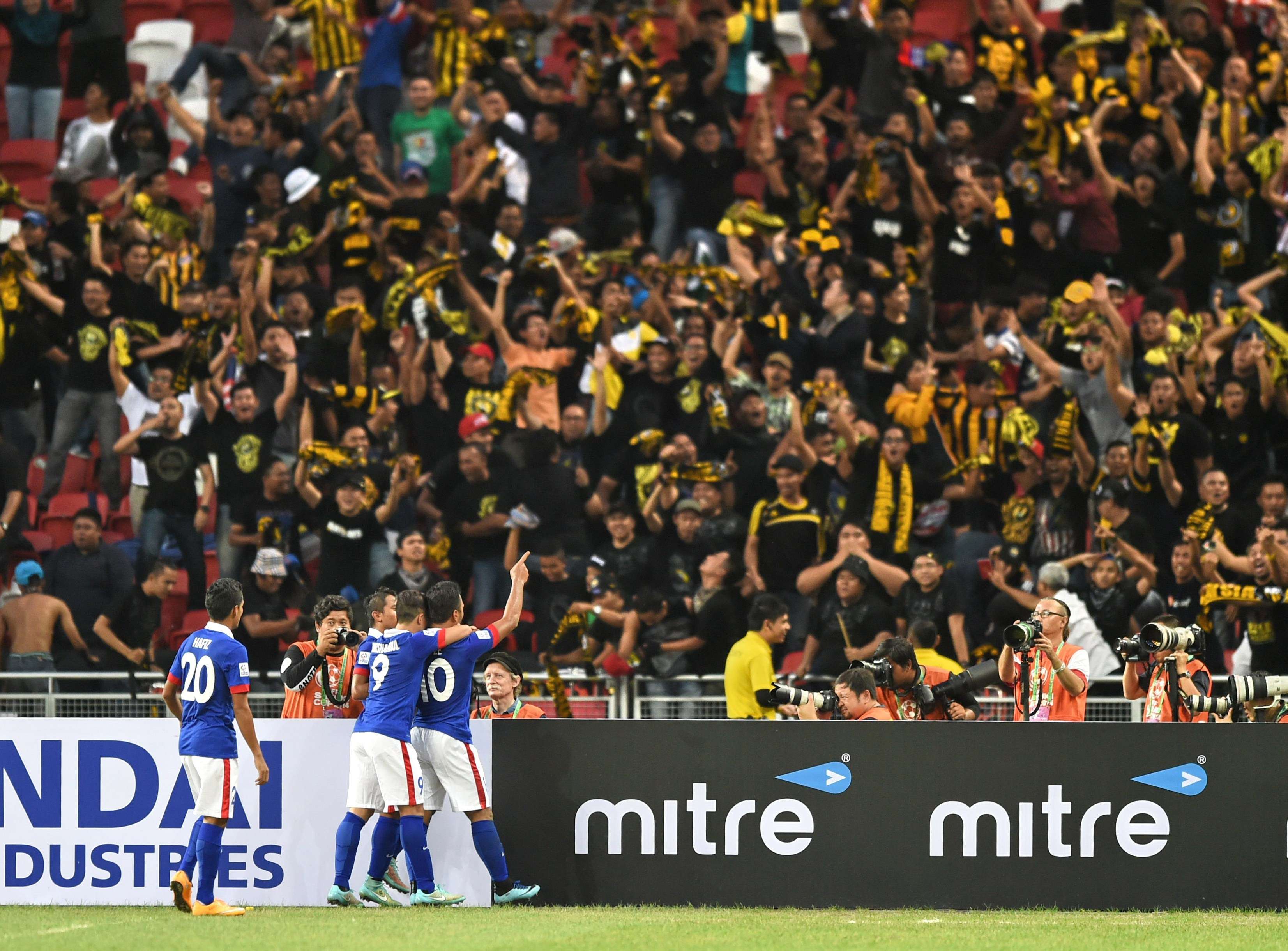 Malaysian players celebrating a goal against Singapore in the 2014 AFF Suzuki Cup