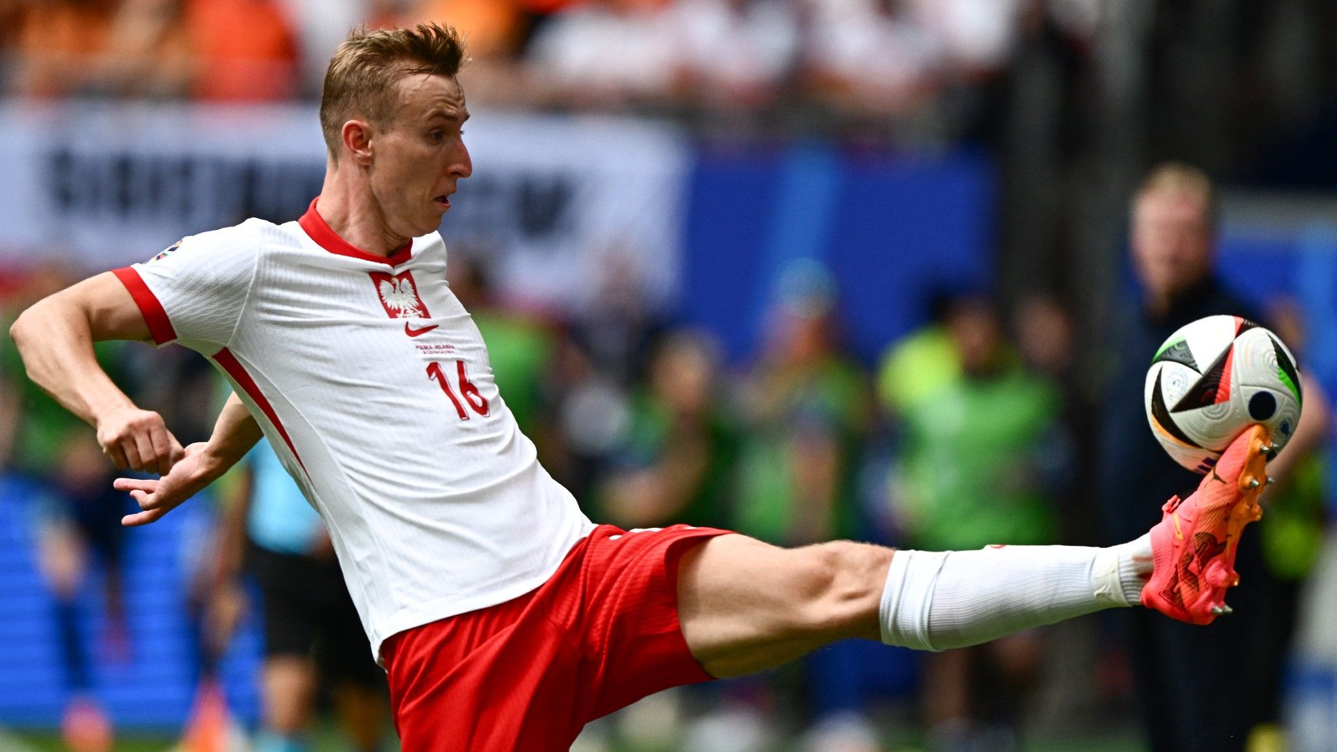 Poland's forward #16 Adam Buksa controls the ball 