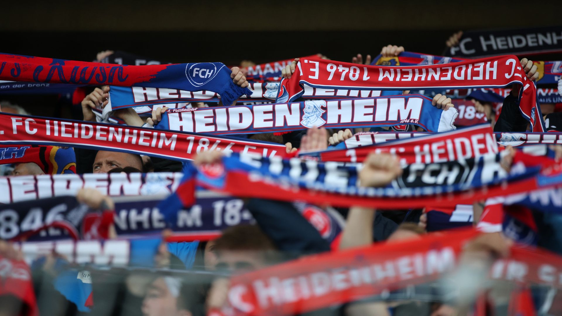 Fans of 1.FC Heidenheim 1846 show their support as they hold scarves prior to the Bundesliga playoffs