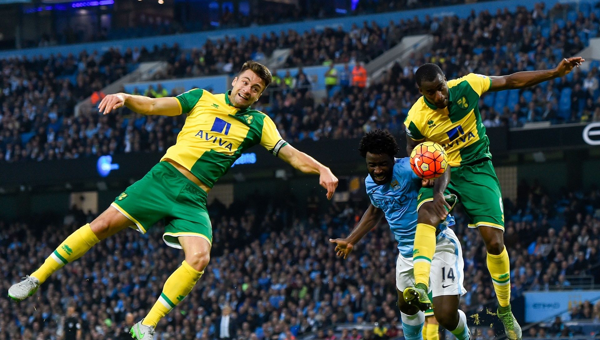 Wilfried Bony (C) of Manchester City, Russel Martin (L) and Sebastien Bassong of Norwich City