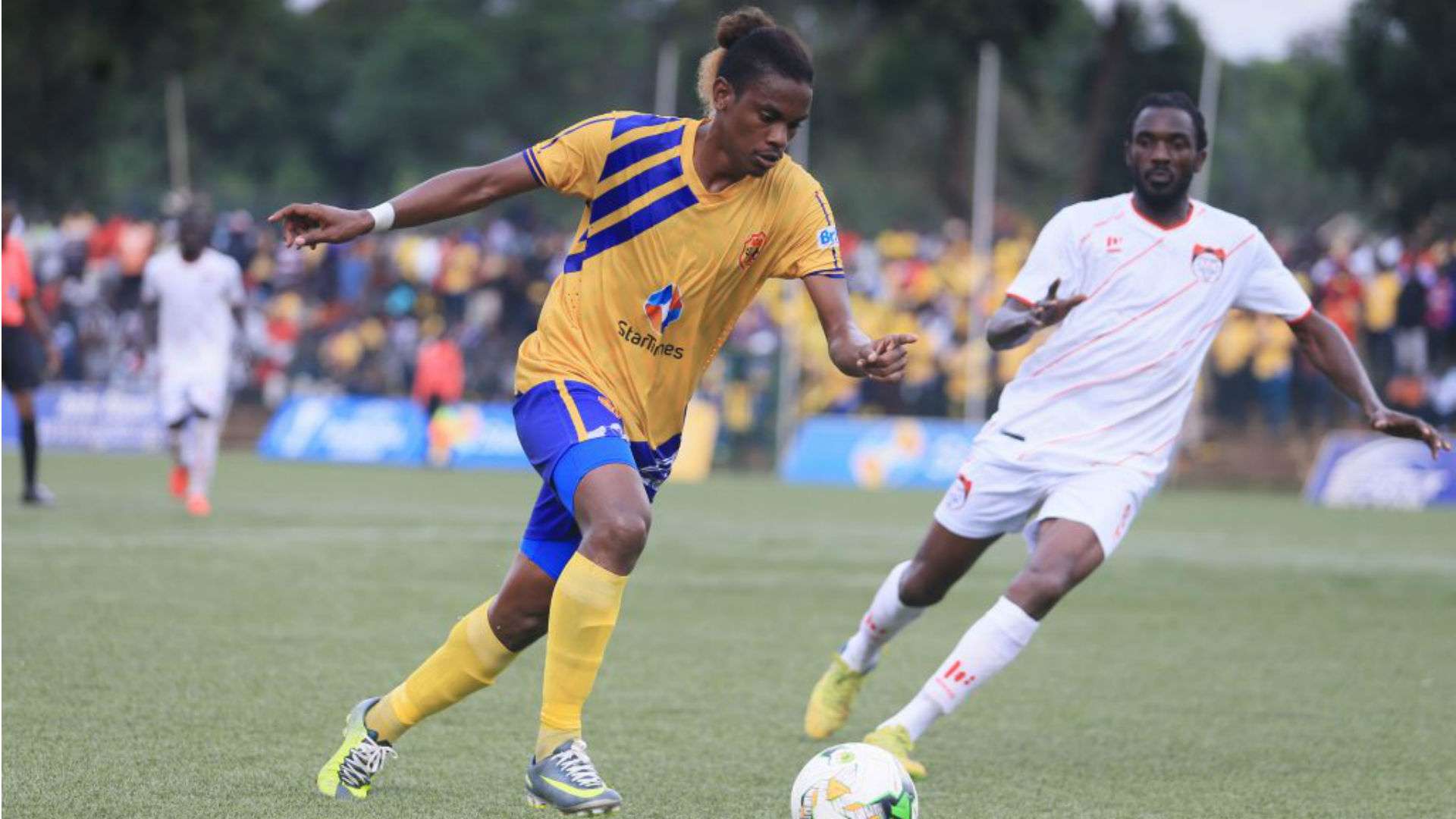 John Revita (L) dribbles past an opponent of KCCA FC vs Kyetume FC.