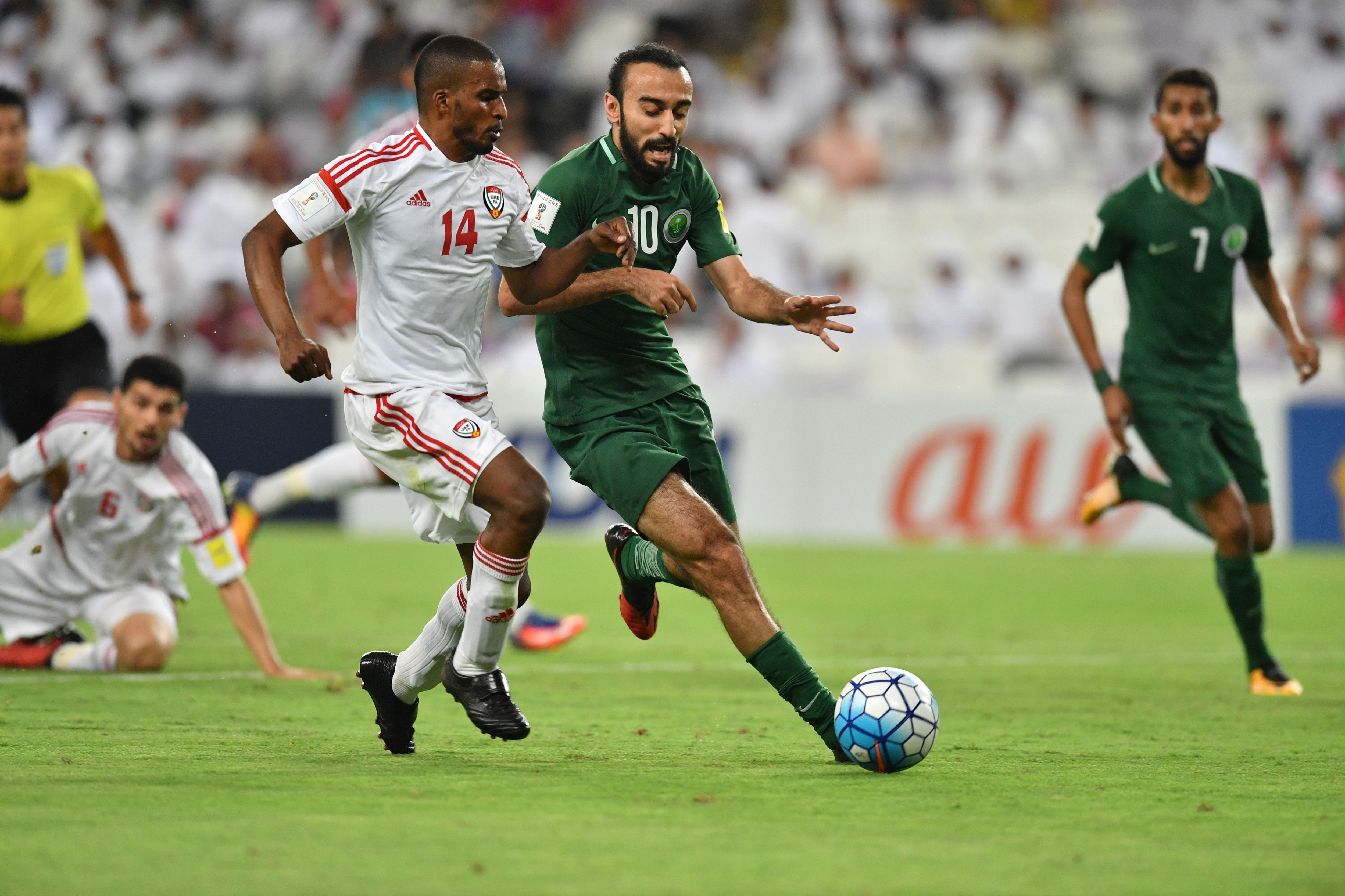 UAE's defender Mahmoud Khamis (L) fights for the ball with Saudi's forward Mohammed al-Sahlawi.jpg
