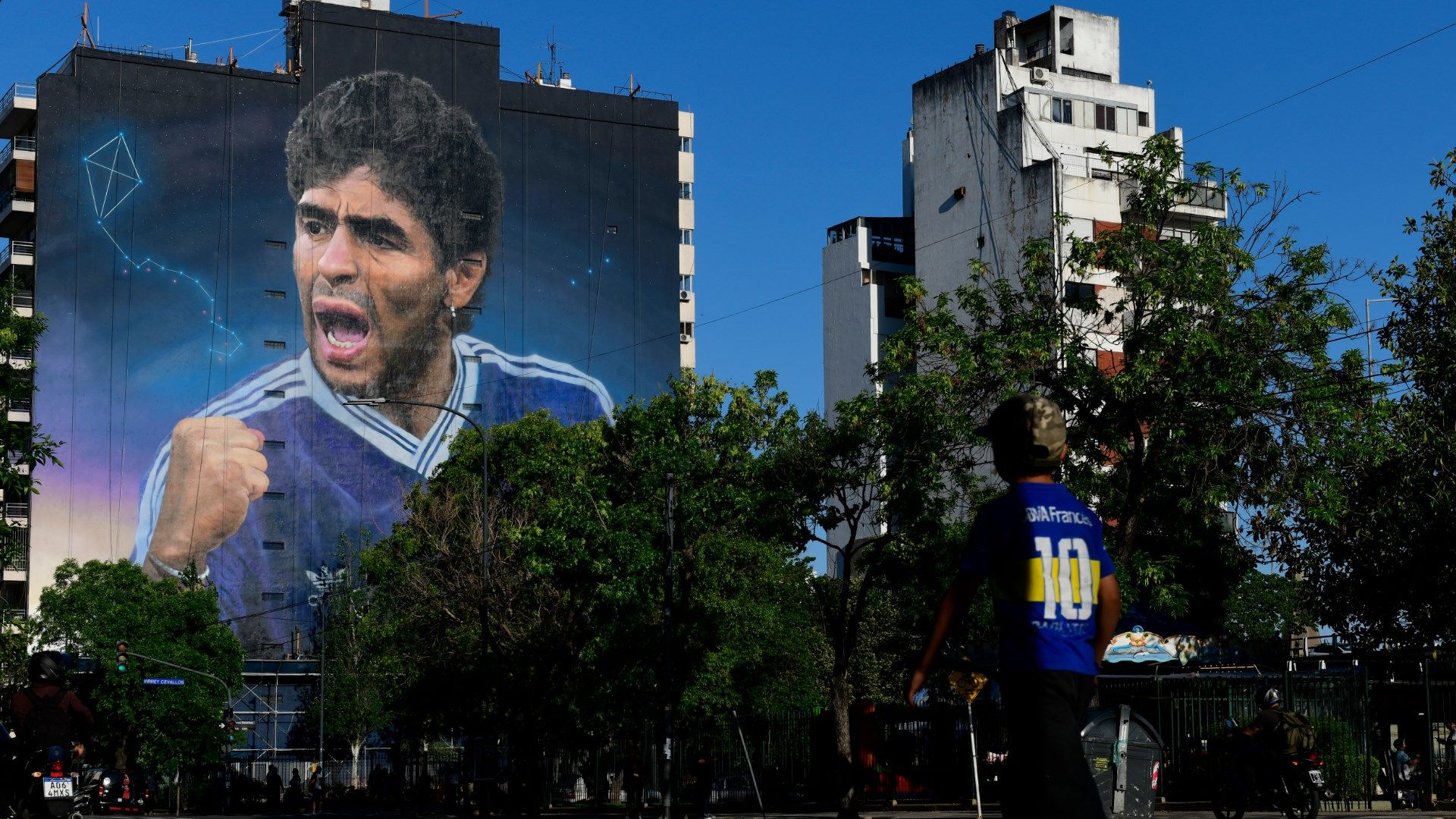 Diego Maradona mural and boy wearing No. 10 Boca jersey Buenos Aires Argentina