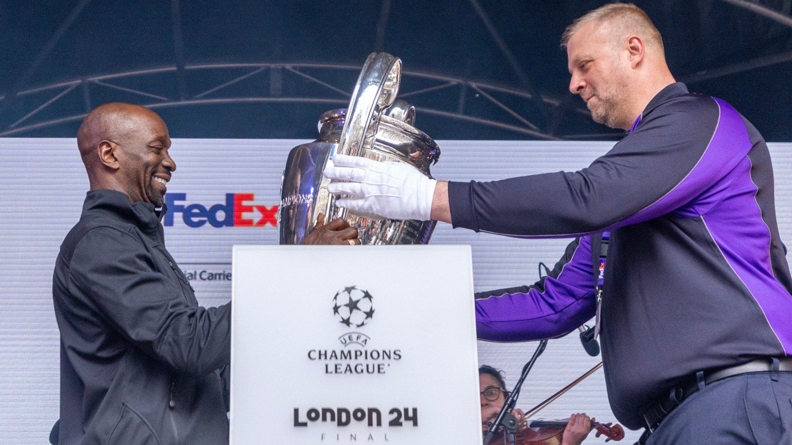 Football fans surprised with incredible live performance of iconic UEFA Champions League anthem as FedEx deliver the trophy to London ahead of huge Borussia Dortmund vs Real Madrid final at Wembley | Goal.com UK
