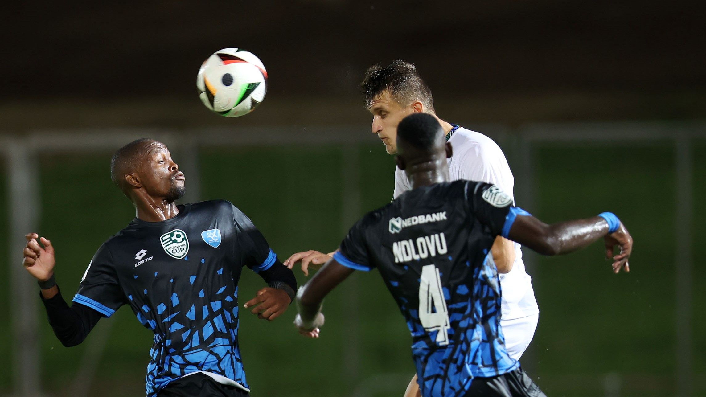 Siyavuya Ndlovu of Durban City challenges TS Galaxy striker Dzenan Zajmovic