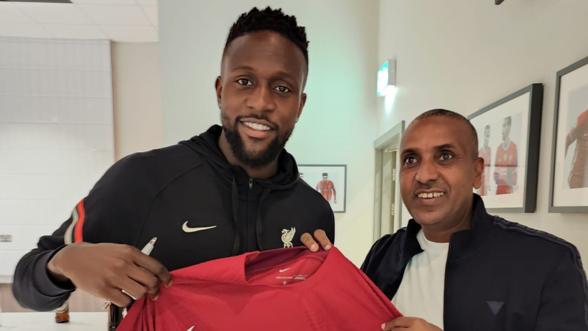  FKF Twaha Mbarak with DIVOCK Origi of Liverpool.