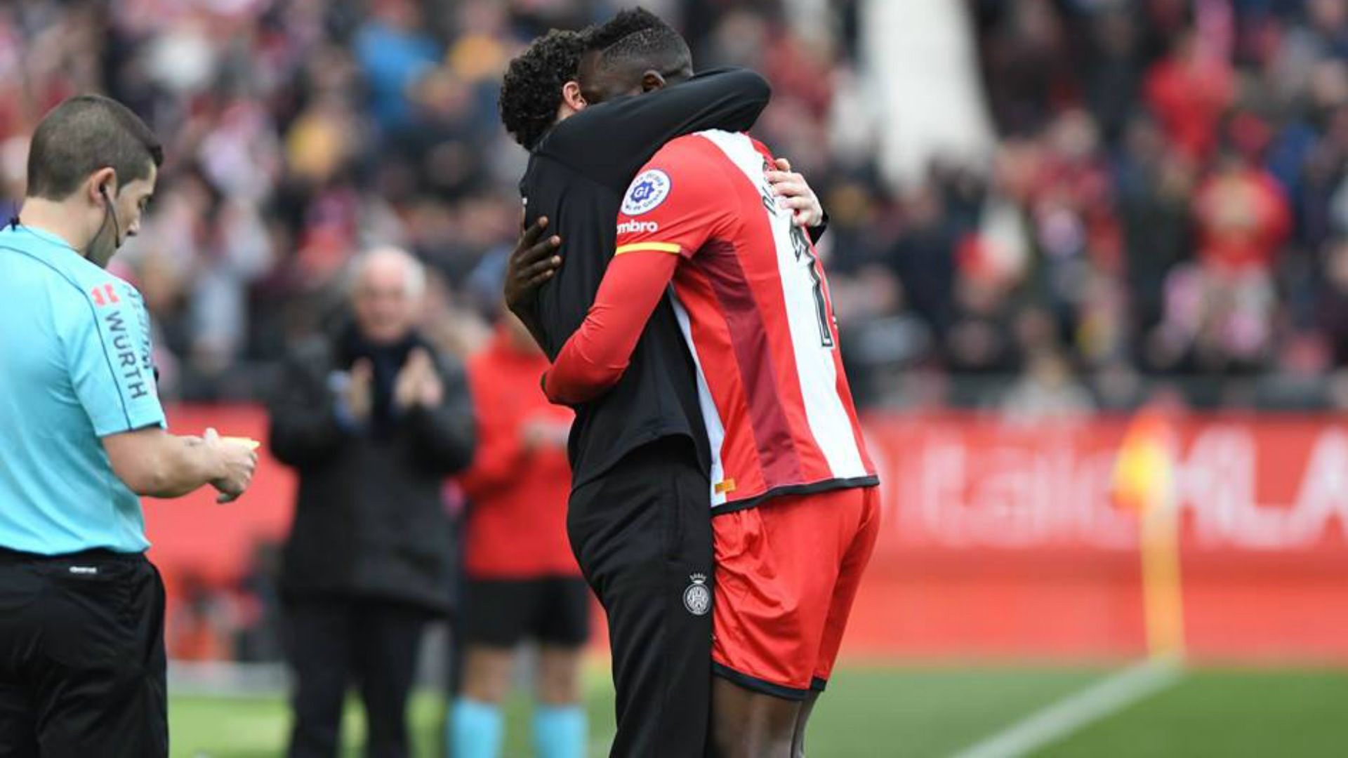 Michael Olunga celebrates with the Girona FC coach.