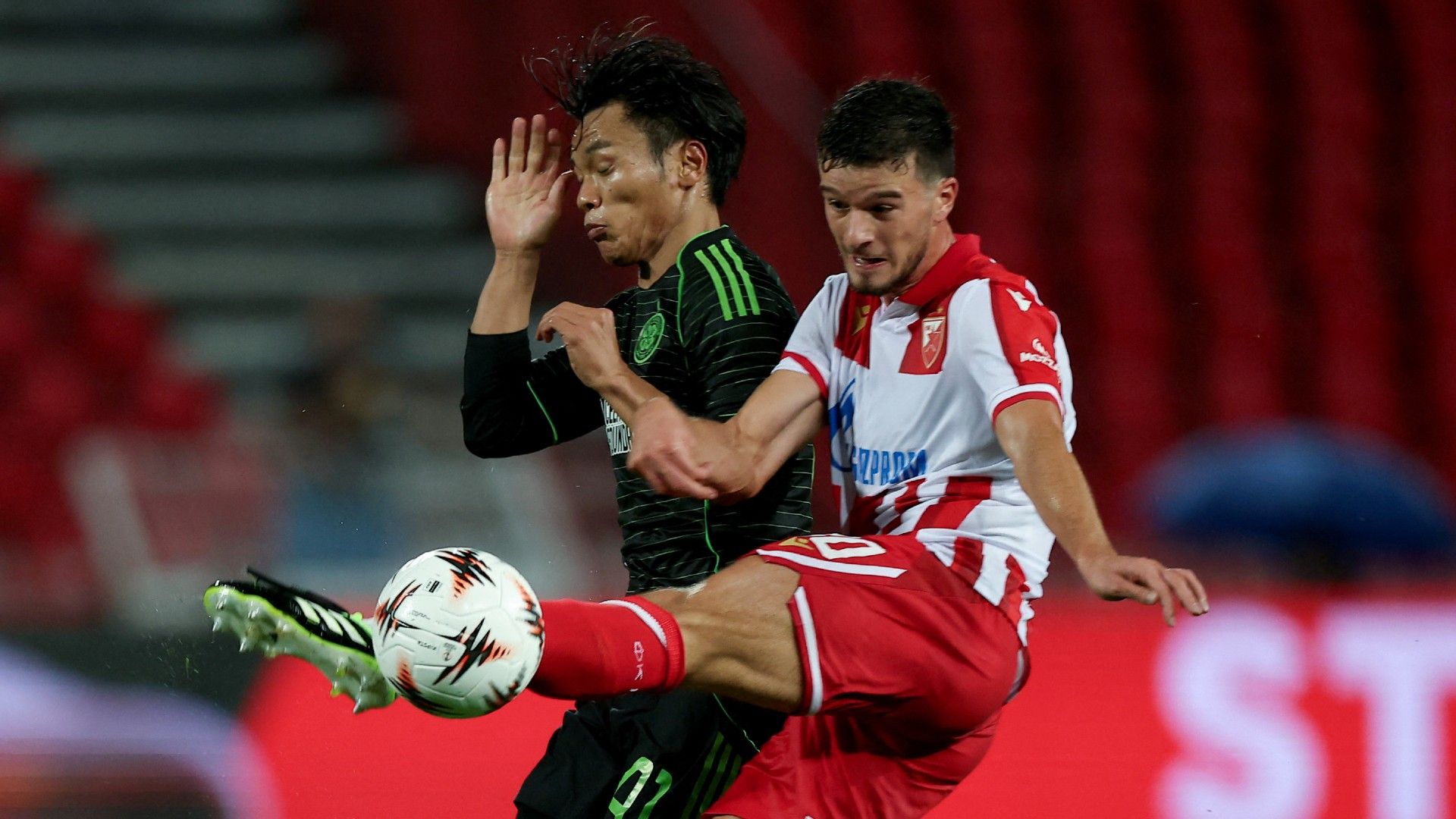 Crvena Zvezda's #20 Tomas Handel (R) vies with Celtic's #41 Reo Hatate