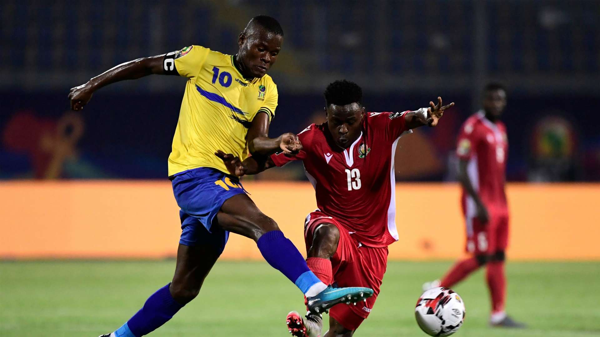 Tanzania's Mbwana Samatta (L) fights for the ball with Kenya's Eric Ouma