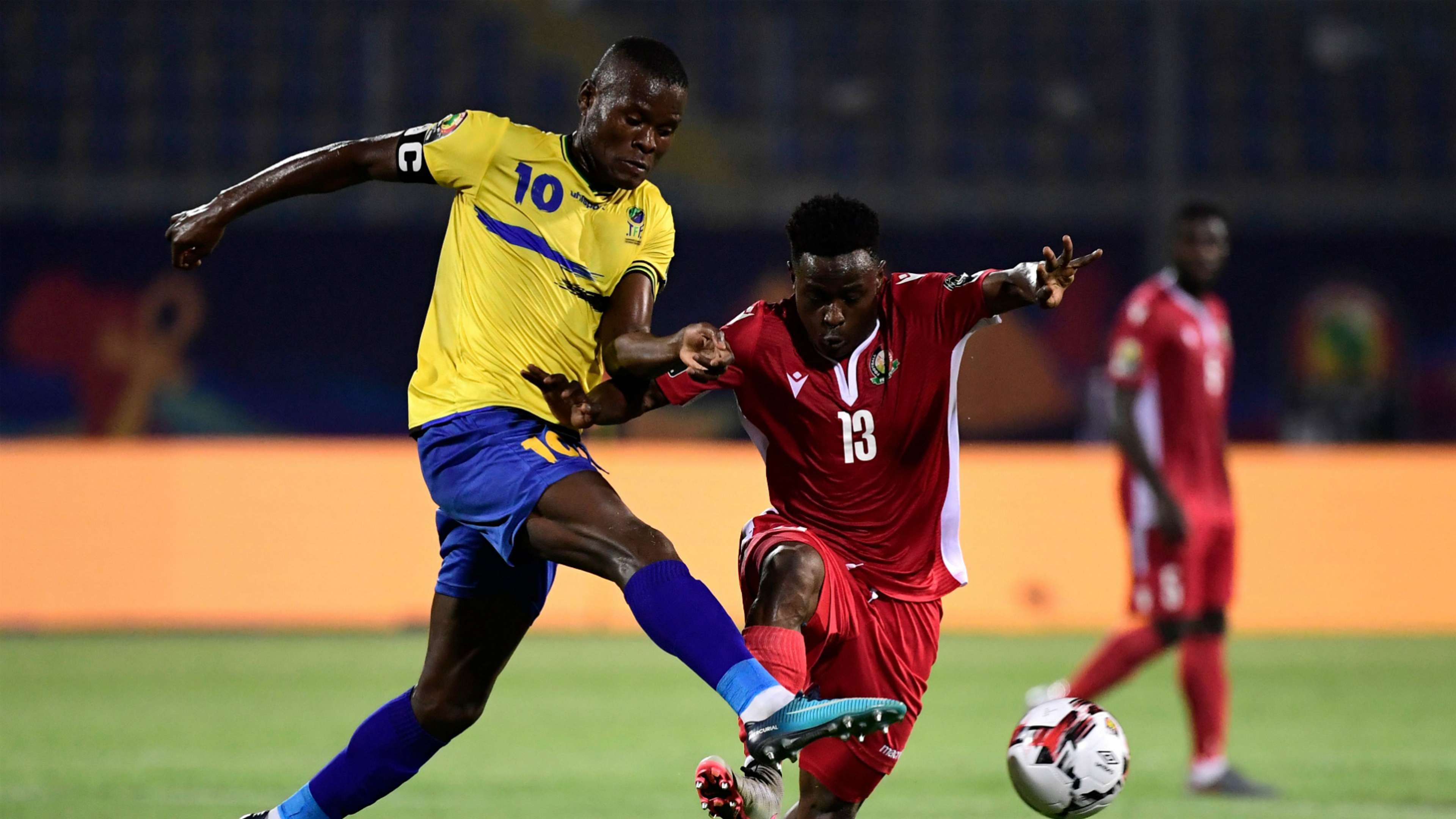 Tanzania's Mbwana Samatta (L) fights for the ball with Kenya's Eric Ouma