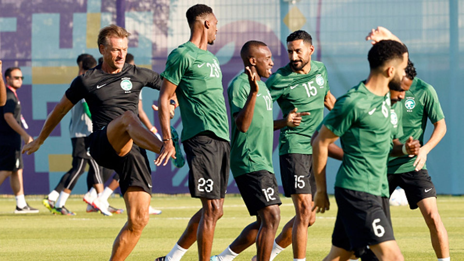 Herve Renard (L) jokes with Saudi Arabia's midfielder #23 Mohamed Kanno 