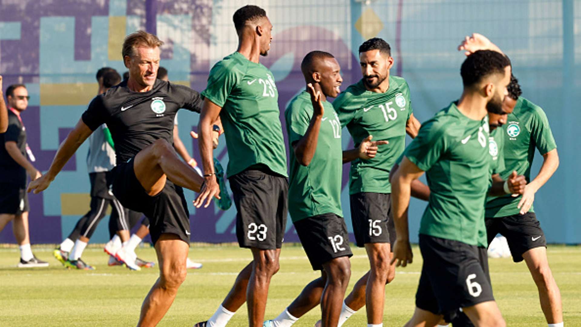 Herve Renard (L) jokes with Saudi Arabia's midfielder #23 Mohamed Kanno