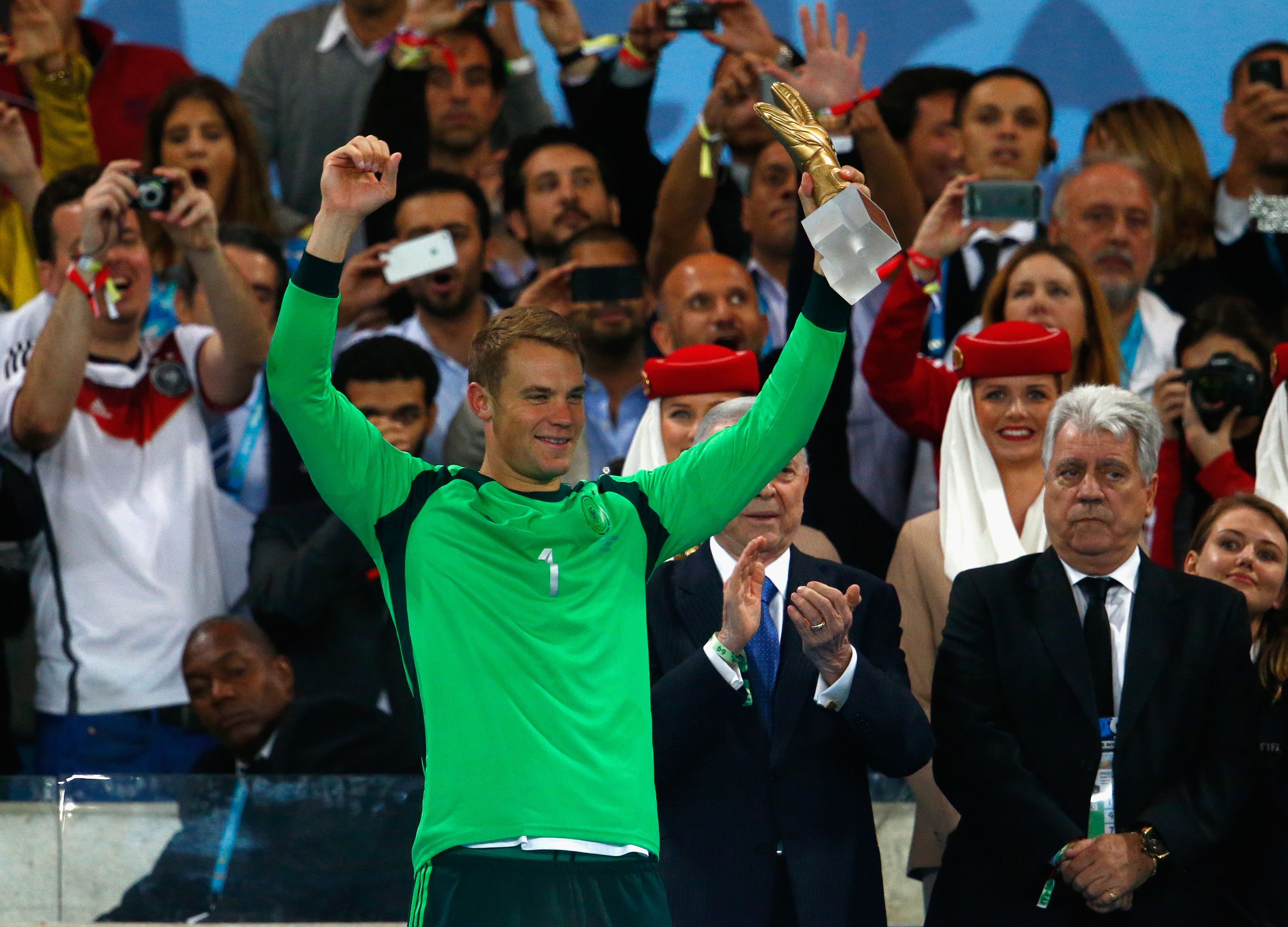 Manuel Neuer of Germany is presented with the Golden Glove trophy during the 2014