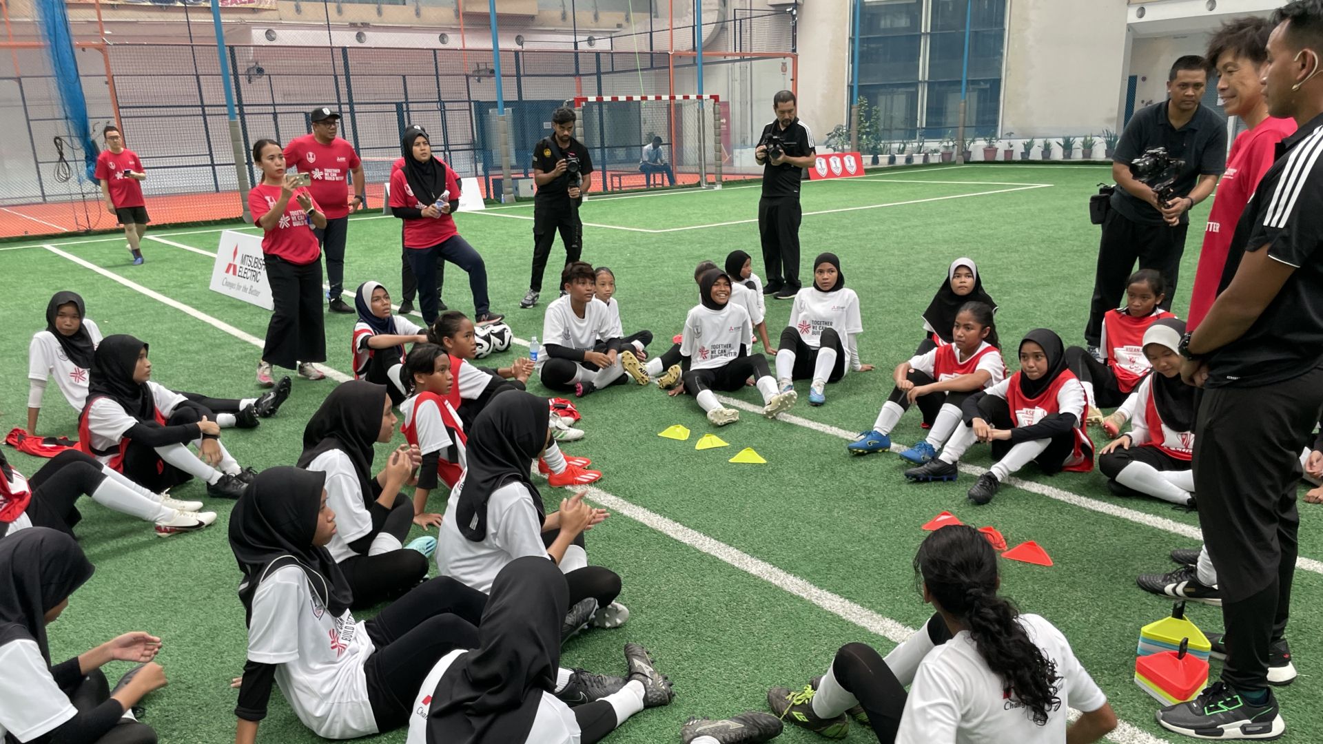Participants listening eagerly during Mitsubishi Electric football clinic MY