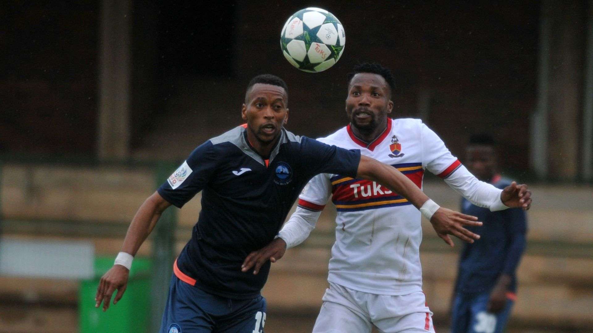 Thabo Moseki of University of Pretoria challenged by Manti Mekoa of Richards Bay FC