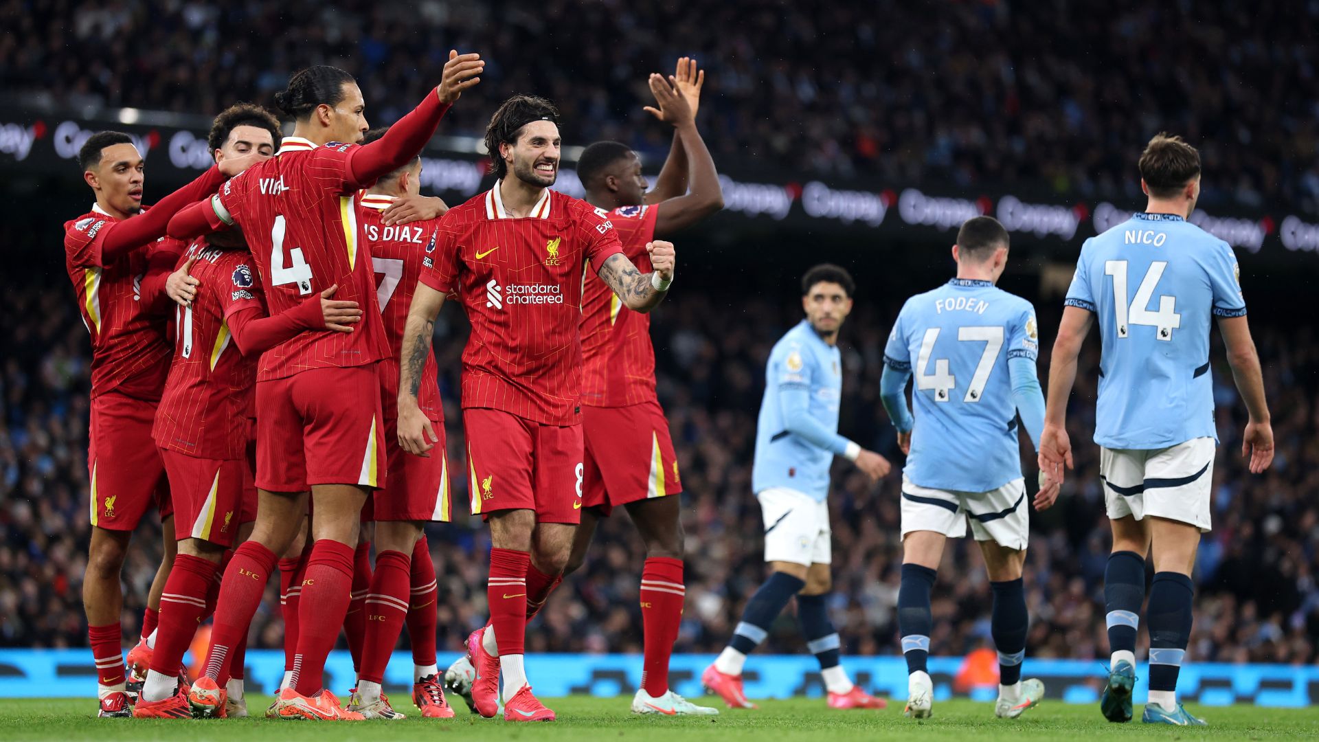 Mohamed Salah of Liverpool celebrates scoring his team's first goal with teammates