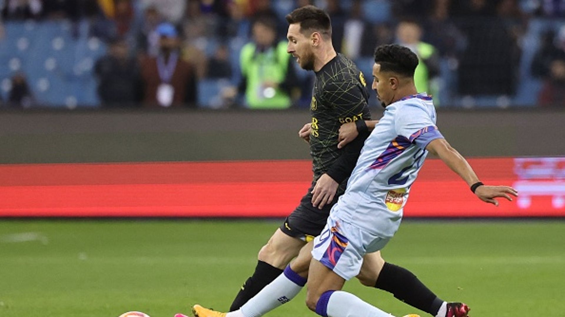 Paris Saint-Germain's Argentine forward Lionel Messi (L) is marked by Riyadh All-Star's Saudi midfielder Salem al-Dawsari during the Riyadh Season Cup
