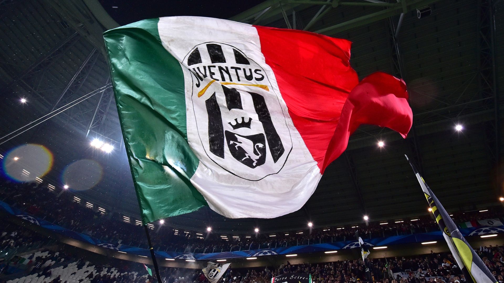 Juventus fans wave a giant flag prior the UEFA Champions League Group A qualifying football match Juventus vs Olympiakos Piraeus at the Juventus stadium 2014