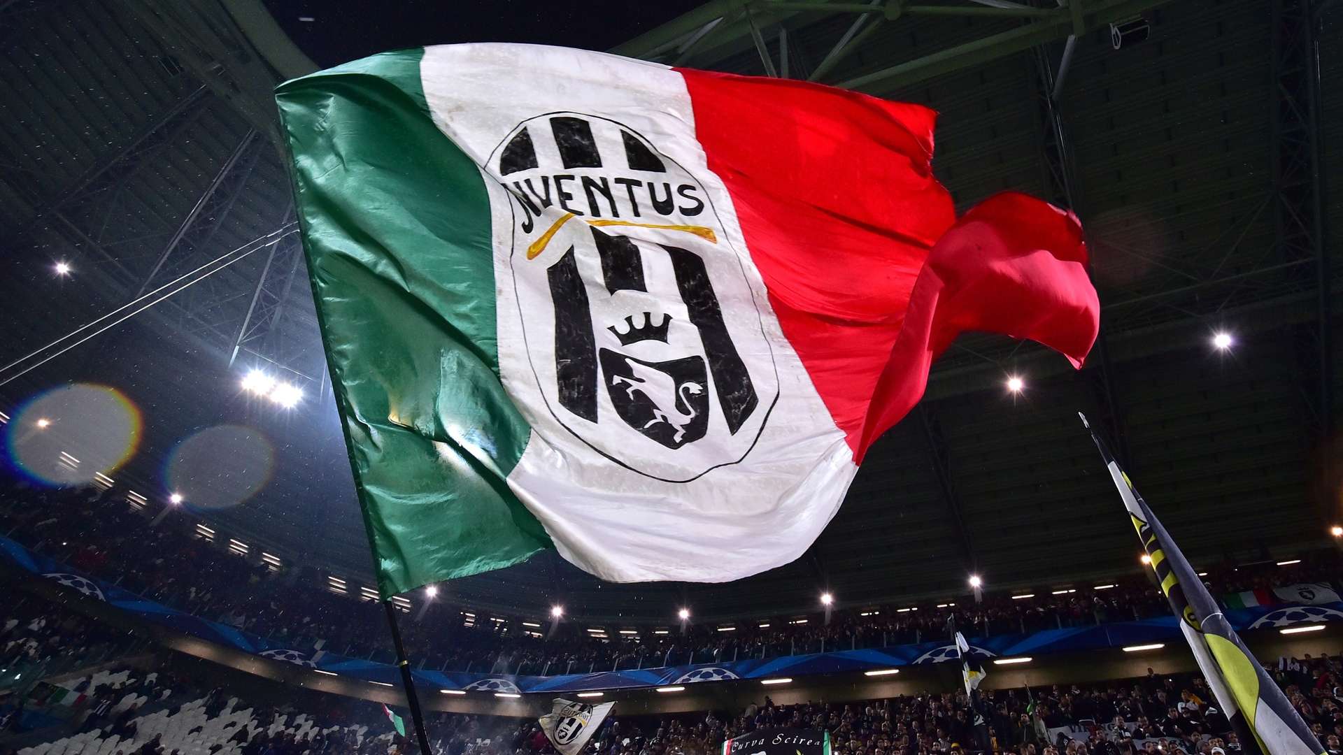 Juventus fans wave a giant flag prior the UEFA Champions League Group A qualifying football match Juventus vs Olympiakos Piraeus at the Juventus stadium 2014