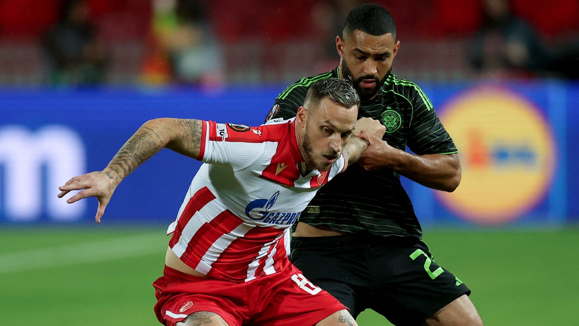 Crvena Zvezda's Marko Arnautovic #89 (L) fights for the ball with Celtic's Cameron Carter-Vickers #20 (R)