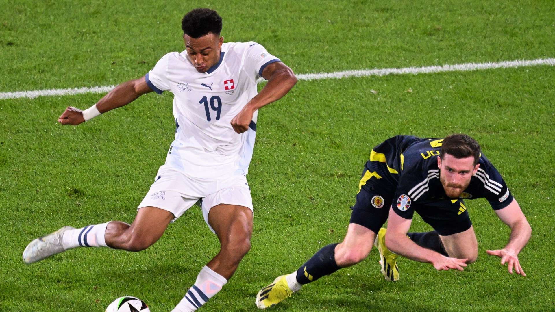 Switzerland's Dan Ndoye bursts past Anthony Ralston of Scotland