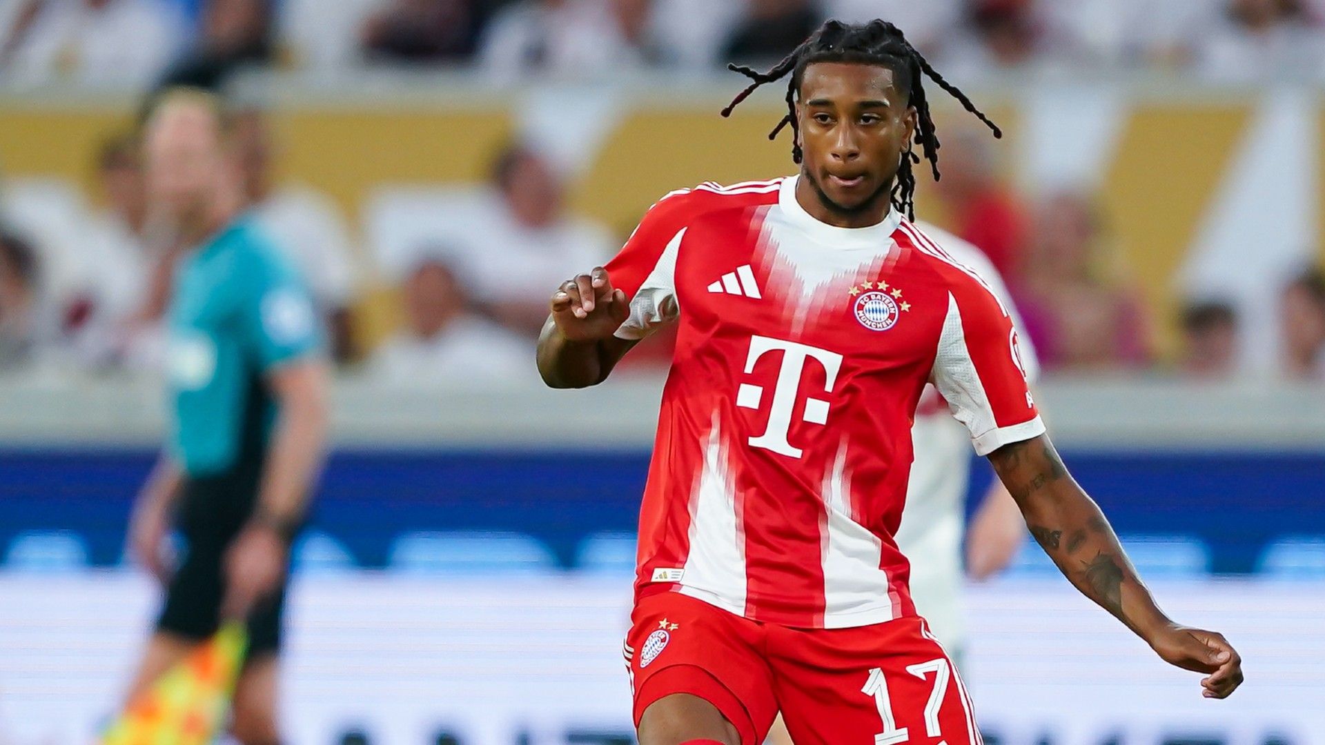 Michael Olise of Bayern Munich passes the ball