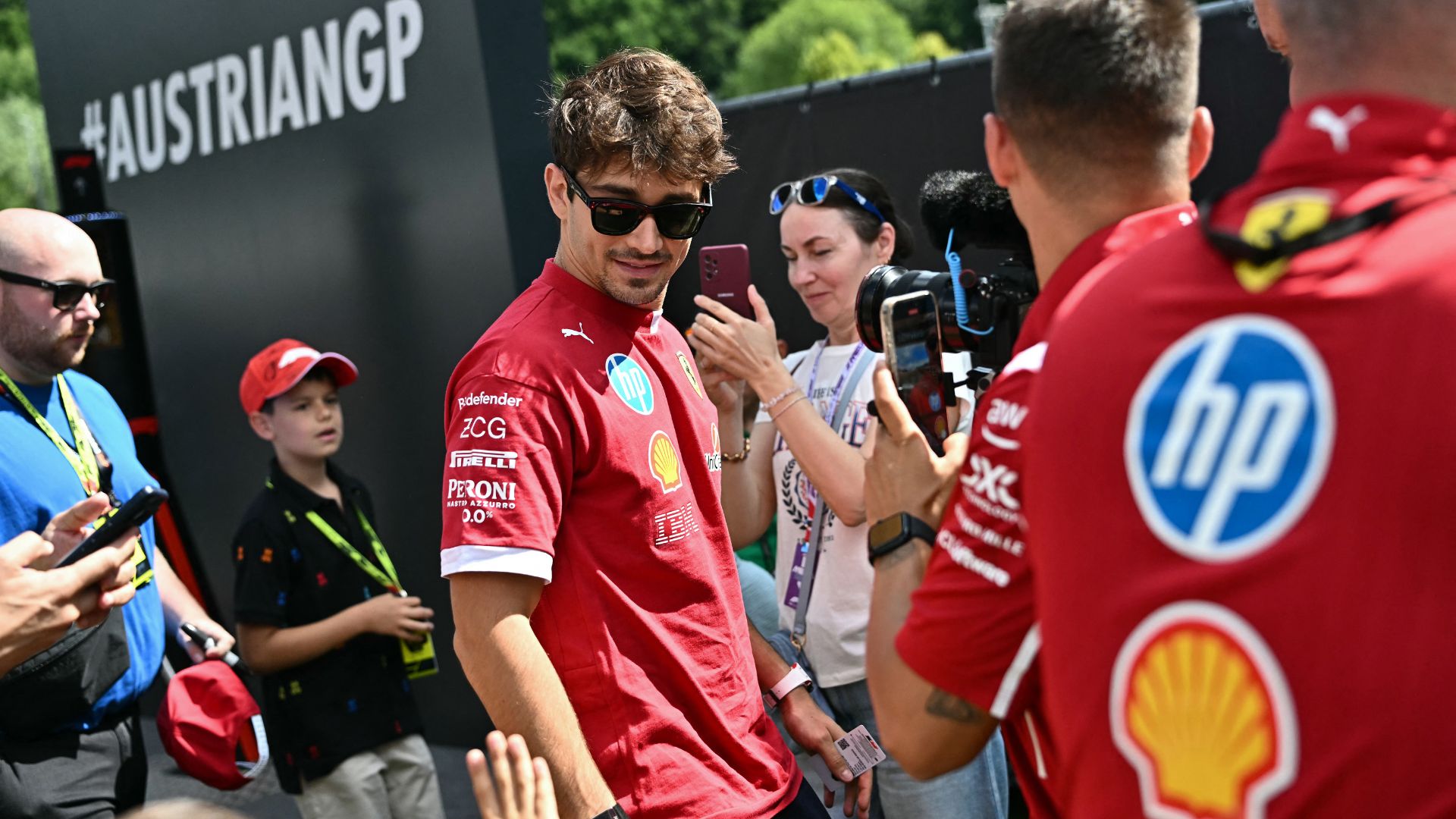 Ferrari's Monegasque driver Charles Leclerc greets fans in Spielberg Austria