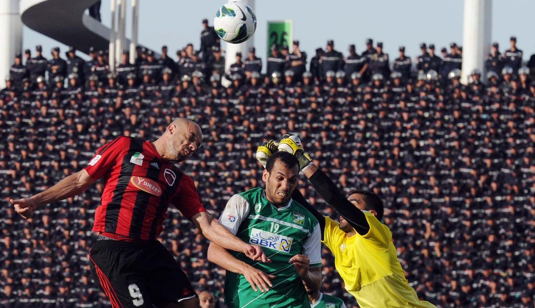 Algeria's USM Alger club player Nuredine Daham (L) fights for the ball with Kuwait's Al-Arabi Kader Fall