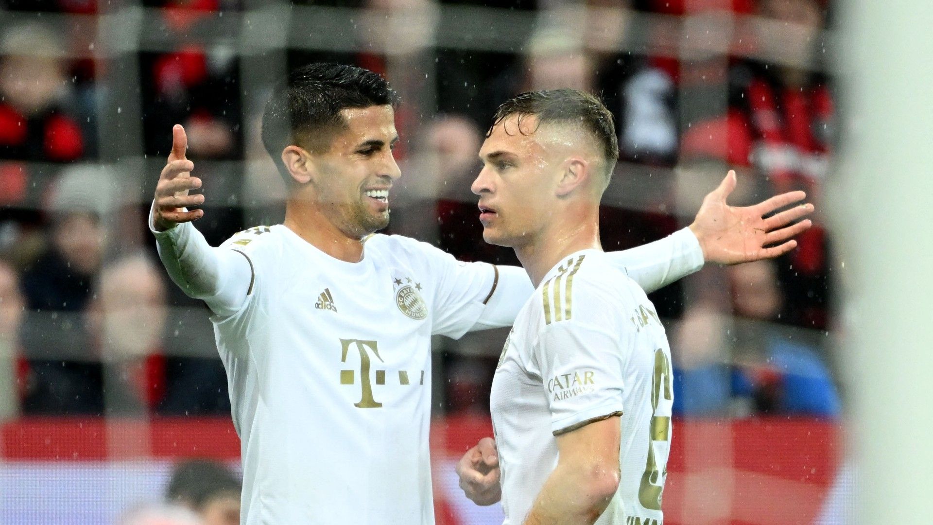 Bayern Munich's German midfielder Joshua Kimmich (R) celebrates with Bayern Munich's Portuguese defender Joao Cancelo