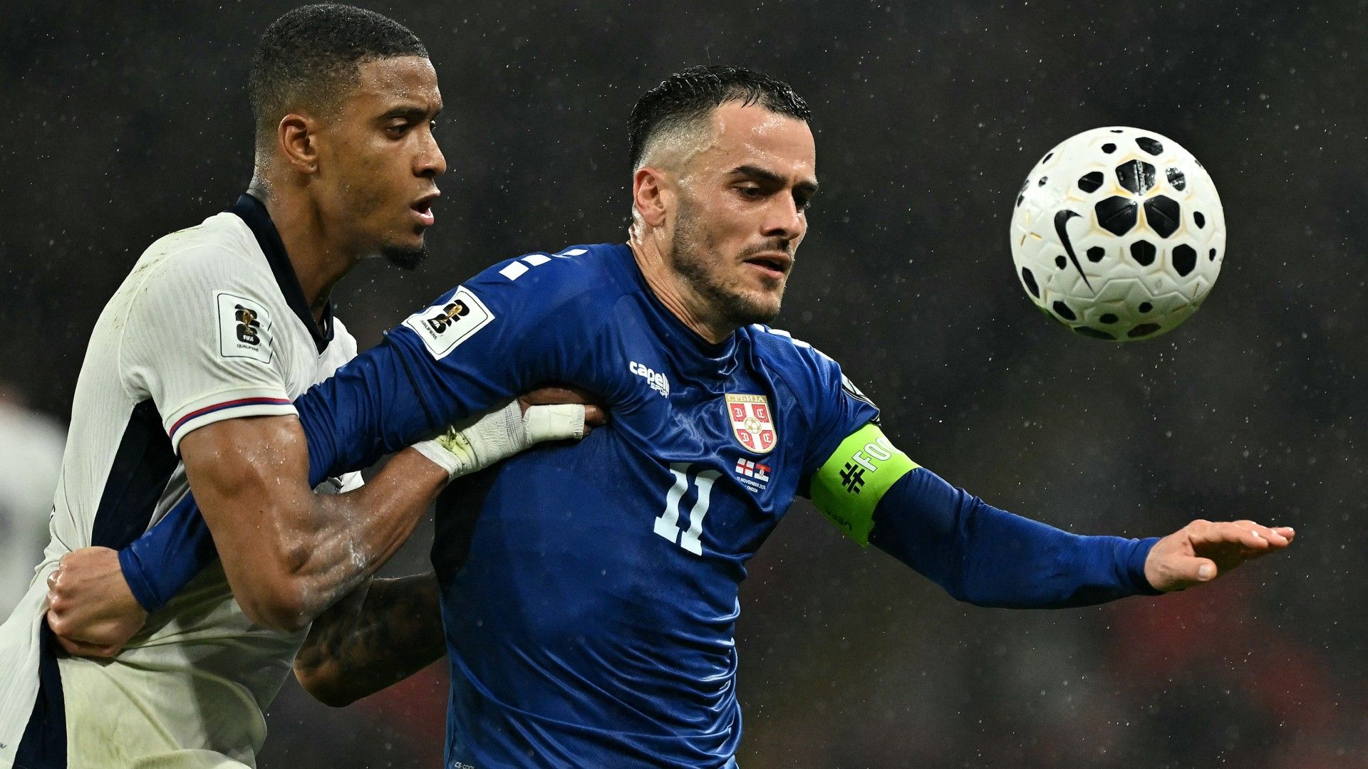 England's defender Ezri Konsa (L) vies with Serbia's midfielder Filip Kostic