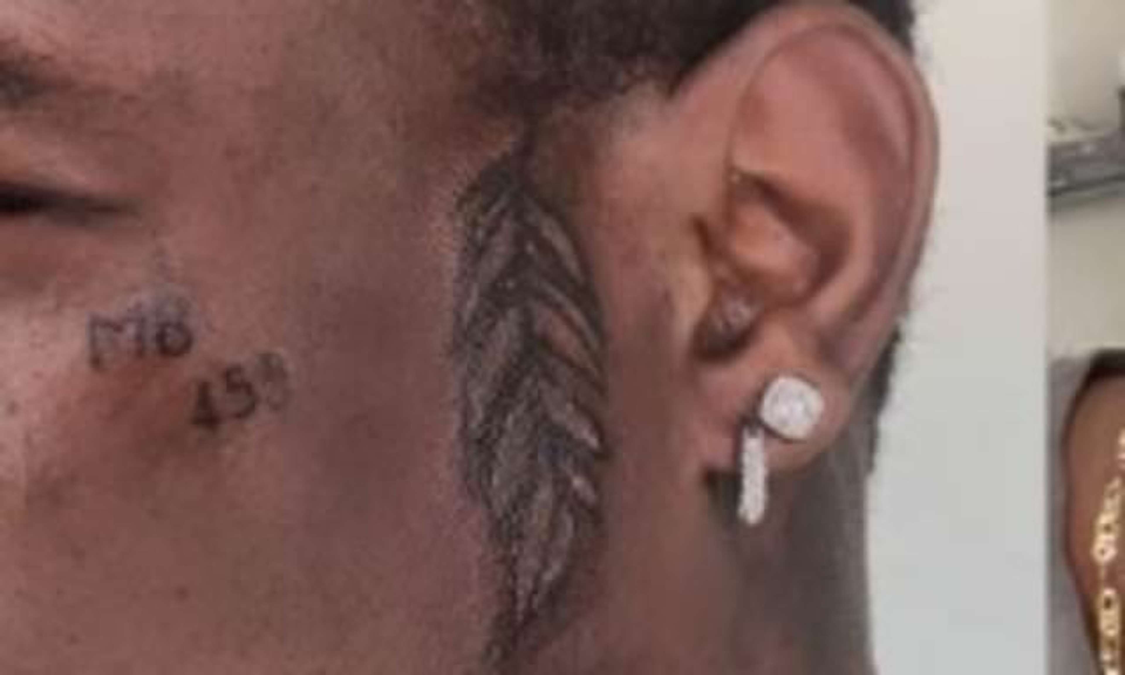 Mario Balotelli face tattoo