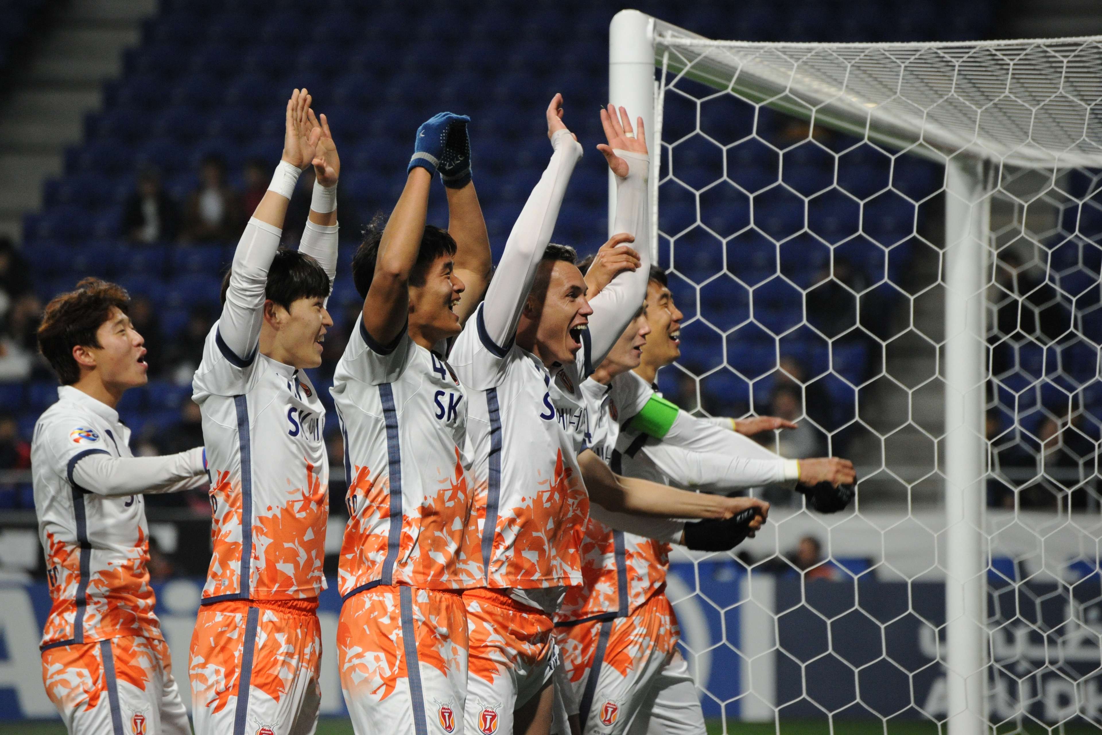 Marcelo Toscano of Jeju United FC and team mates celebrate the third goal during the AFC Champions League Group H match between Gamba Osaka and Jeju United FC