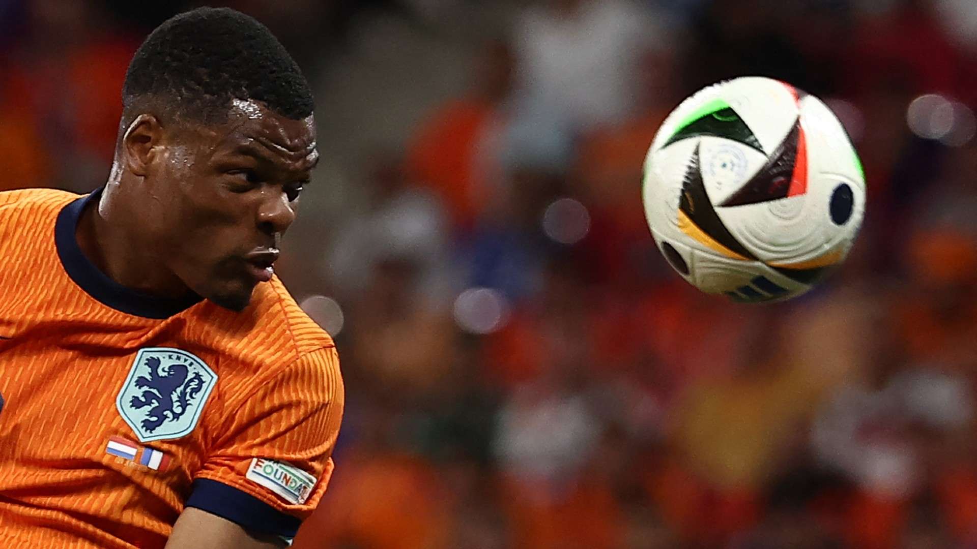 Netherlands' defender #22 Denzel Dumfries heads the ball