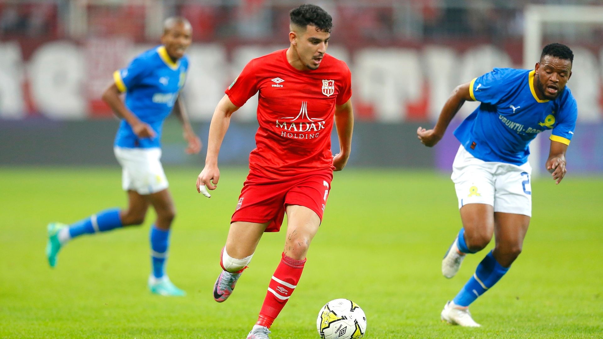 Talal Ishak Boussouf of CR Belouizdad tries to dribble past Sipho Mbule of Mamelodi Sundowns, April 2023