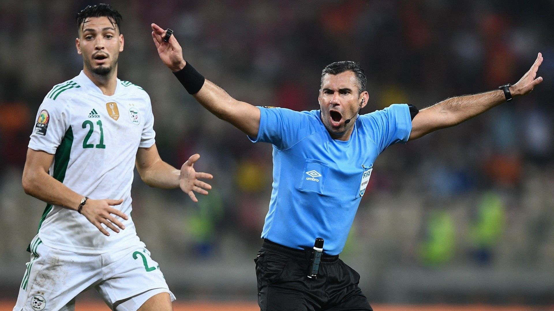 Algeria's defender Ramy Bensebaini (L) reacts