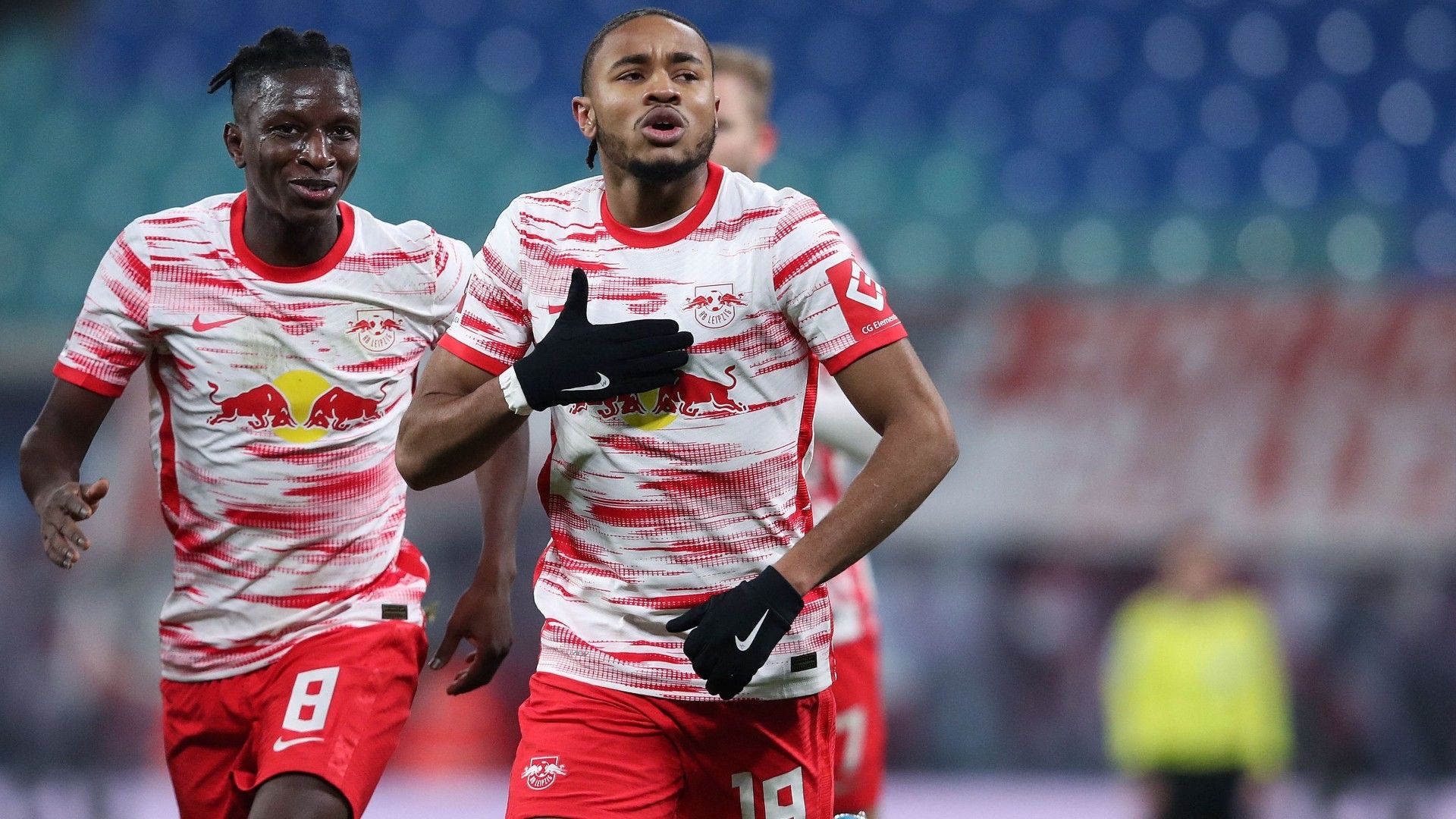 Leipzig's French midfielder Christopher Nkunku (R) celebrates scoring the opening goal with Leipzig's Malian midfielder Amadou Haidara