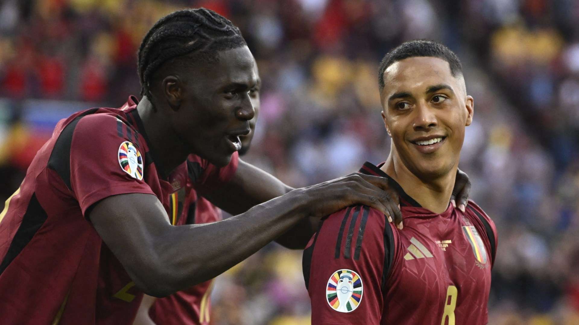 Belgium's Amadou Onana celebrates with Youri Tielemans