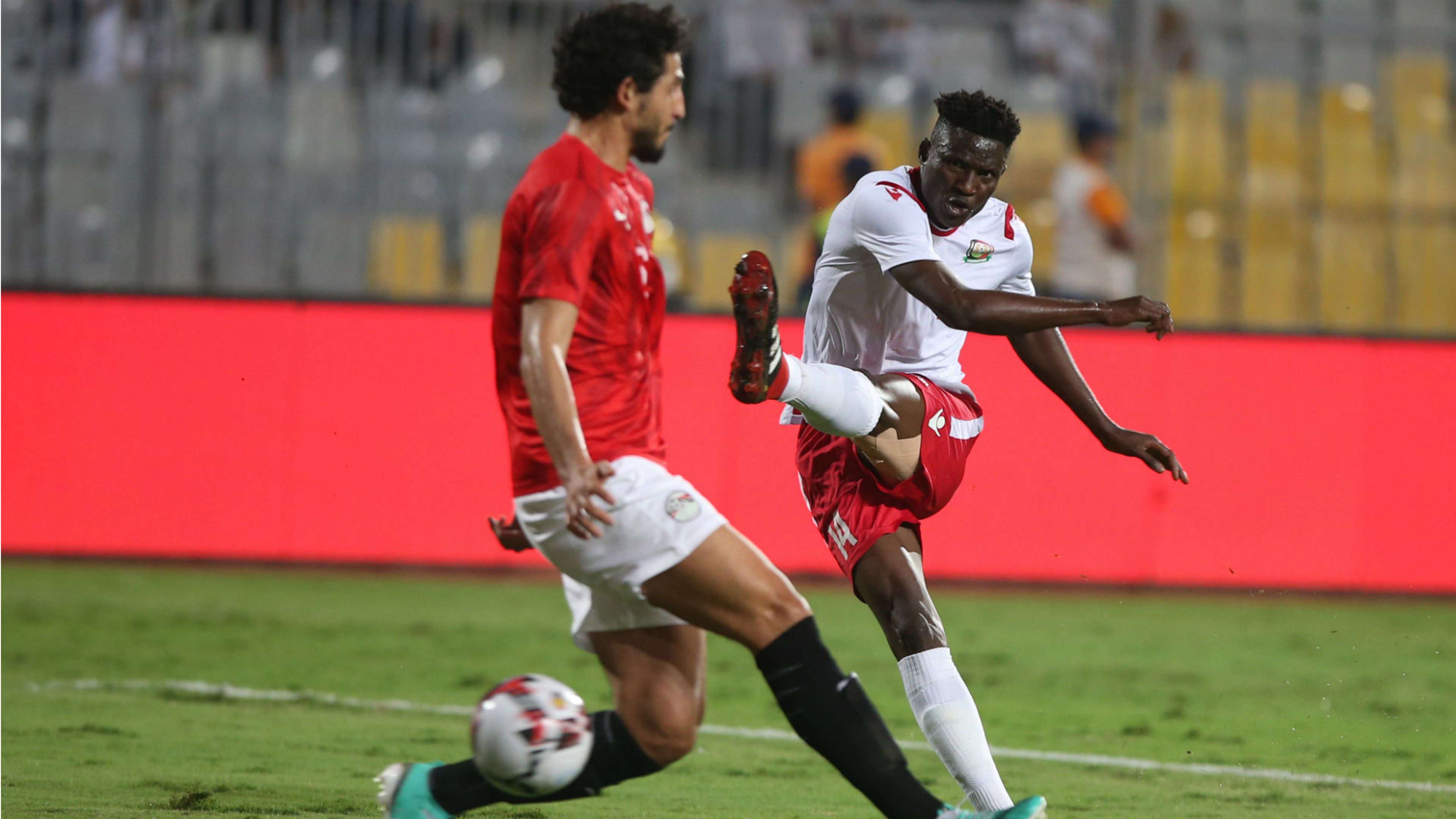 Kenya's Harambee Stars striker Michael Olunga (R) in action against Egypt Player Ahmed Hegazi.