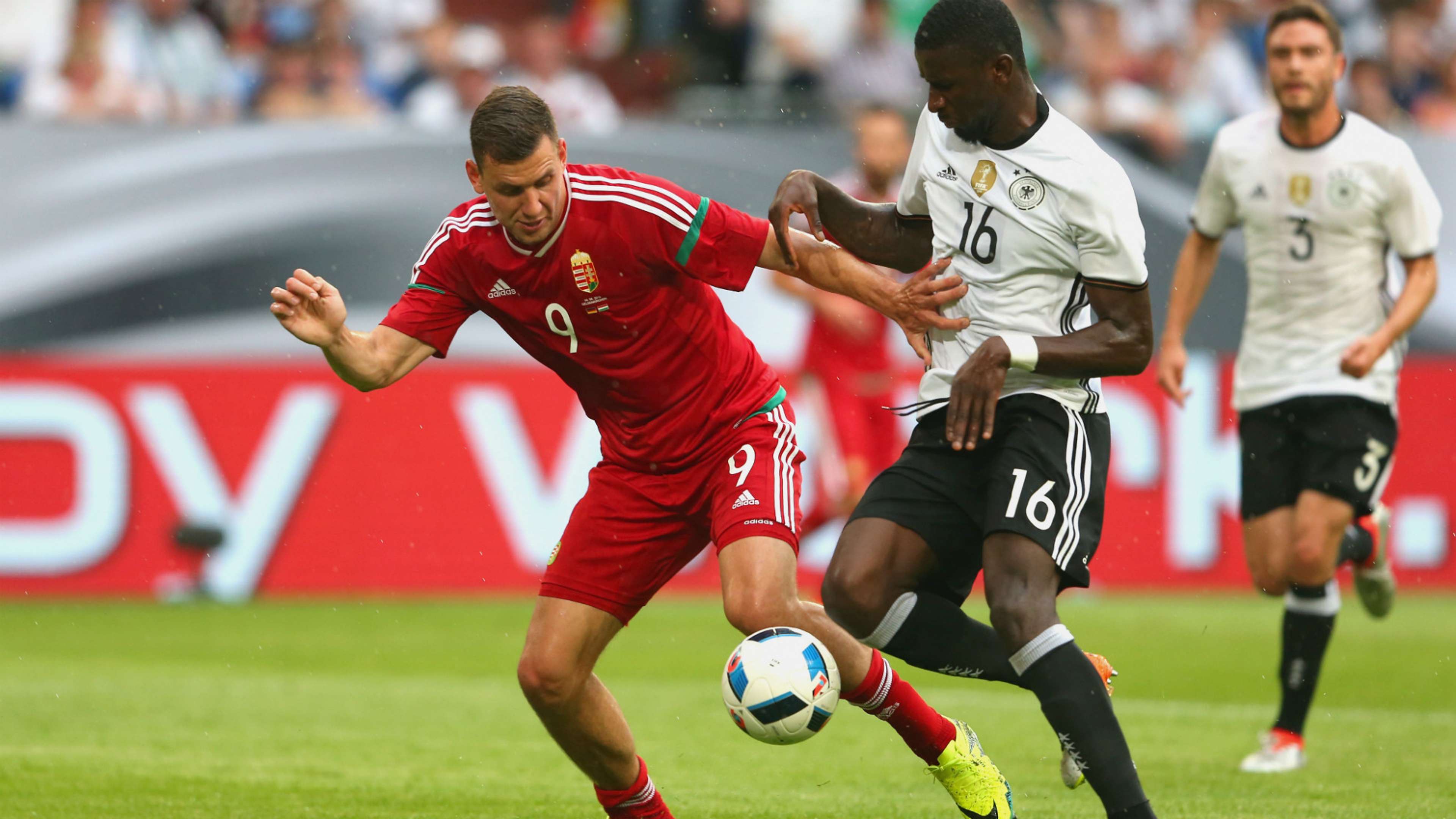 Adam Szalai of Hungary battles for the ball with German defender Antonio Ruediger