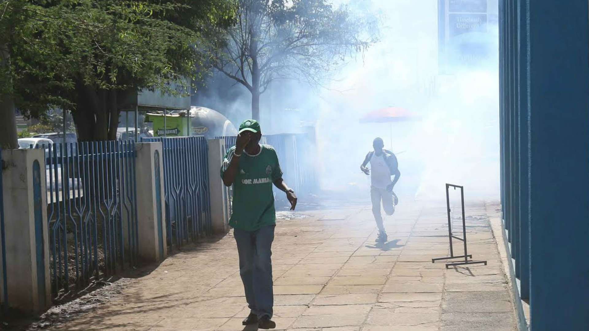 Gor Mahia fans run to safety after police were forced to use teargas
