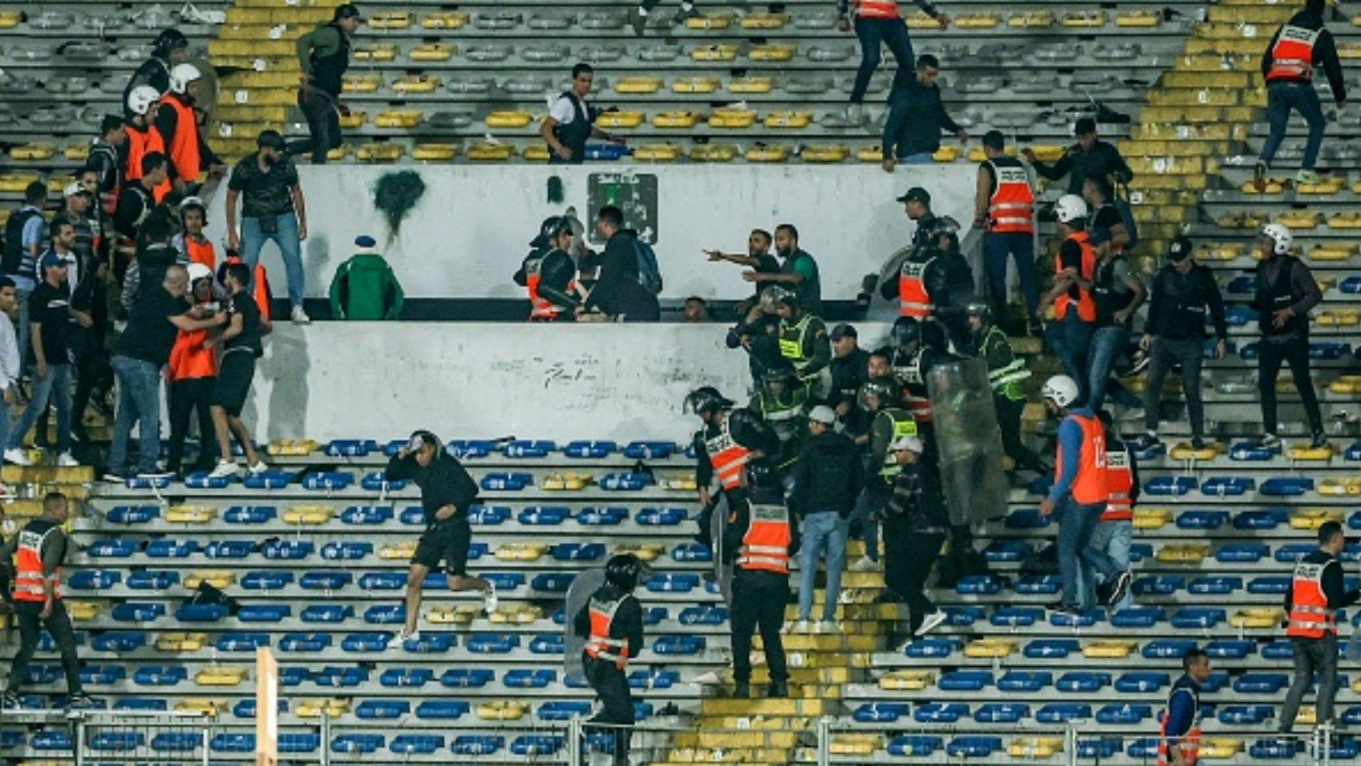  Police breaks up infighting amongst Raja fans during the CAF Champions League quarter-final football match between Morocco's Raja Casablanca and Egypt's Al Ahly
