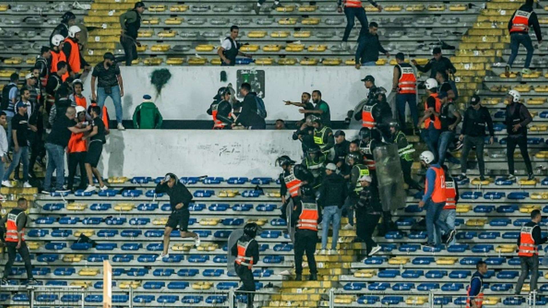 Police breaks up infighting amongst Raja fans during the CAF Champions League quarter-final football match between Morocco's Raja Casablanca and Egypt's Al Ahly