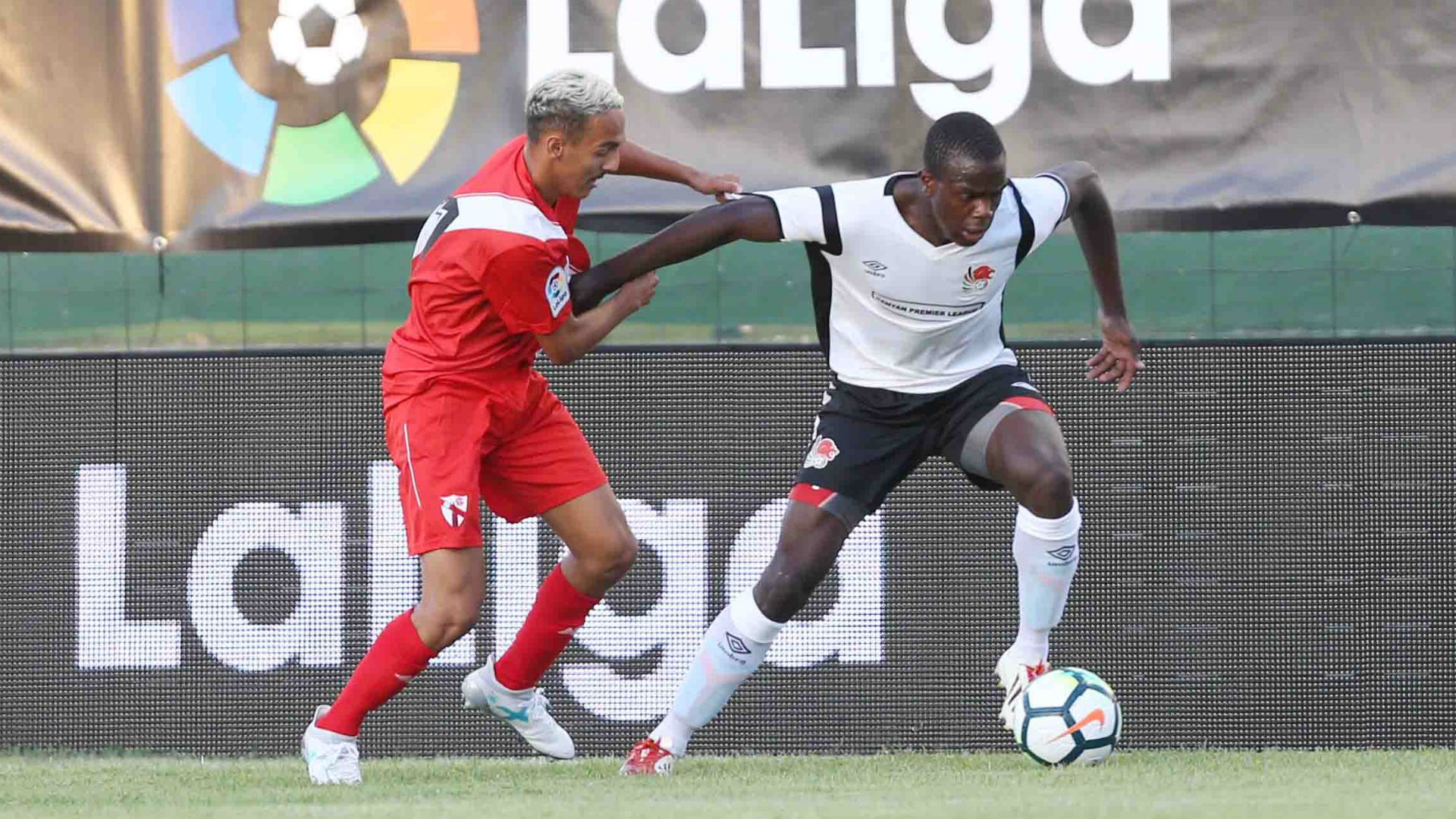 Vincent Oburu ® tackled by Bilal Boutobba of Sevilla