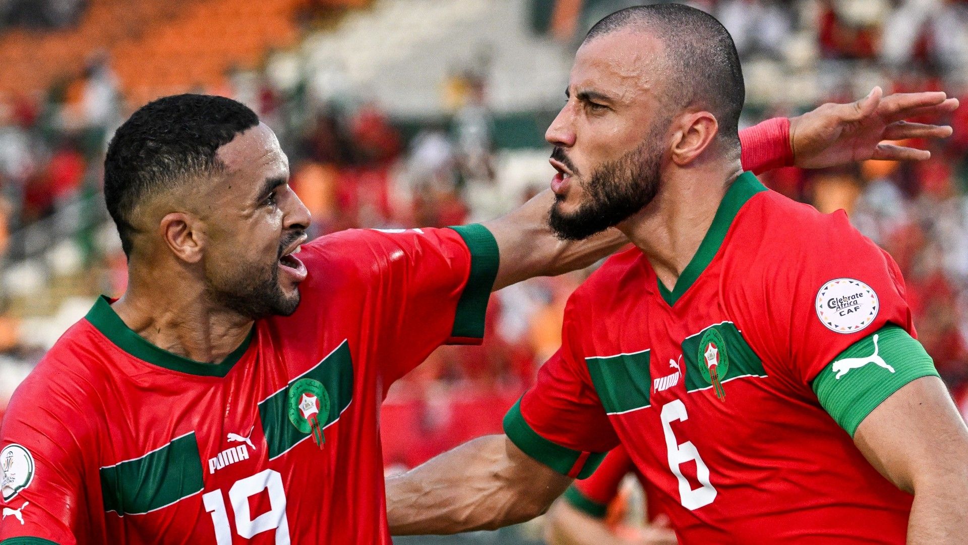 Morocco's defender #6 Romain Saiss (R) celebrates with Morocco's forward #19 Youssef En-Nesyri (L) after scoring