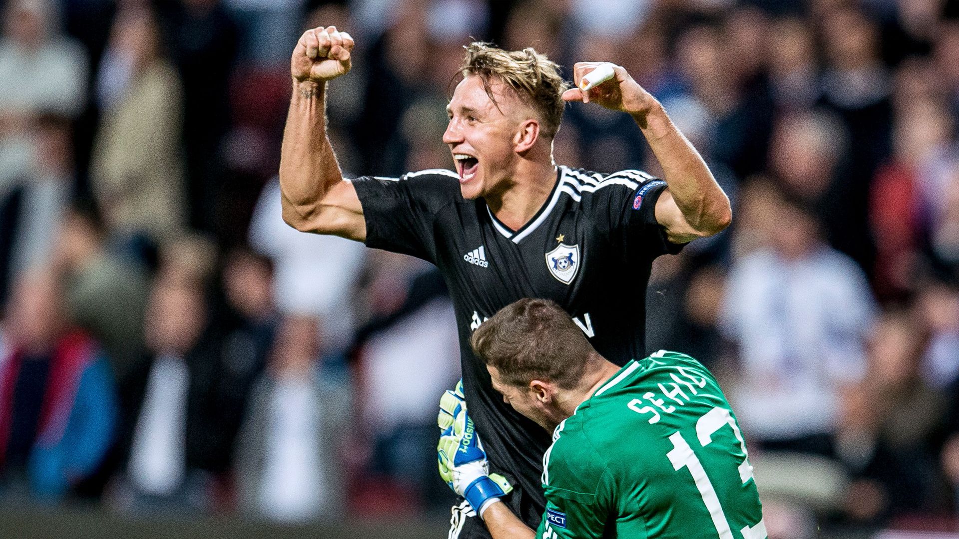 Qarabag's goalkeeper Ibrahim Sehic and Qarabag's Jakub Rzezniczak celebrate