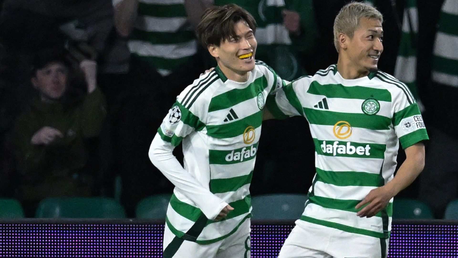 Celtic's Japanese midfielder #08 Kyogo Furuhashi (L) celebrates with Celtic's Japanese striker #38 Daizen Maeda