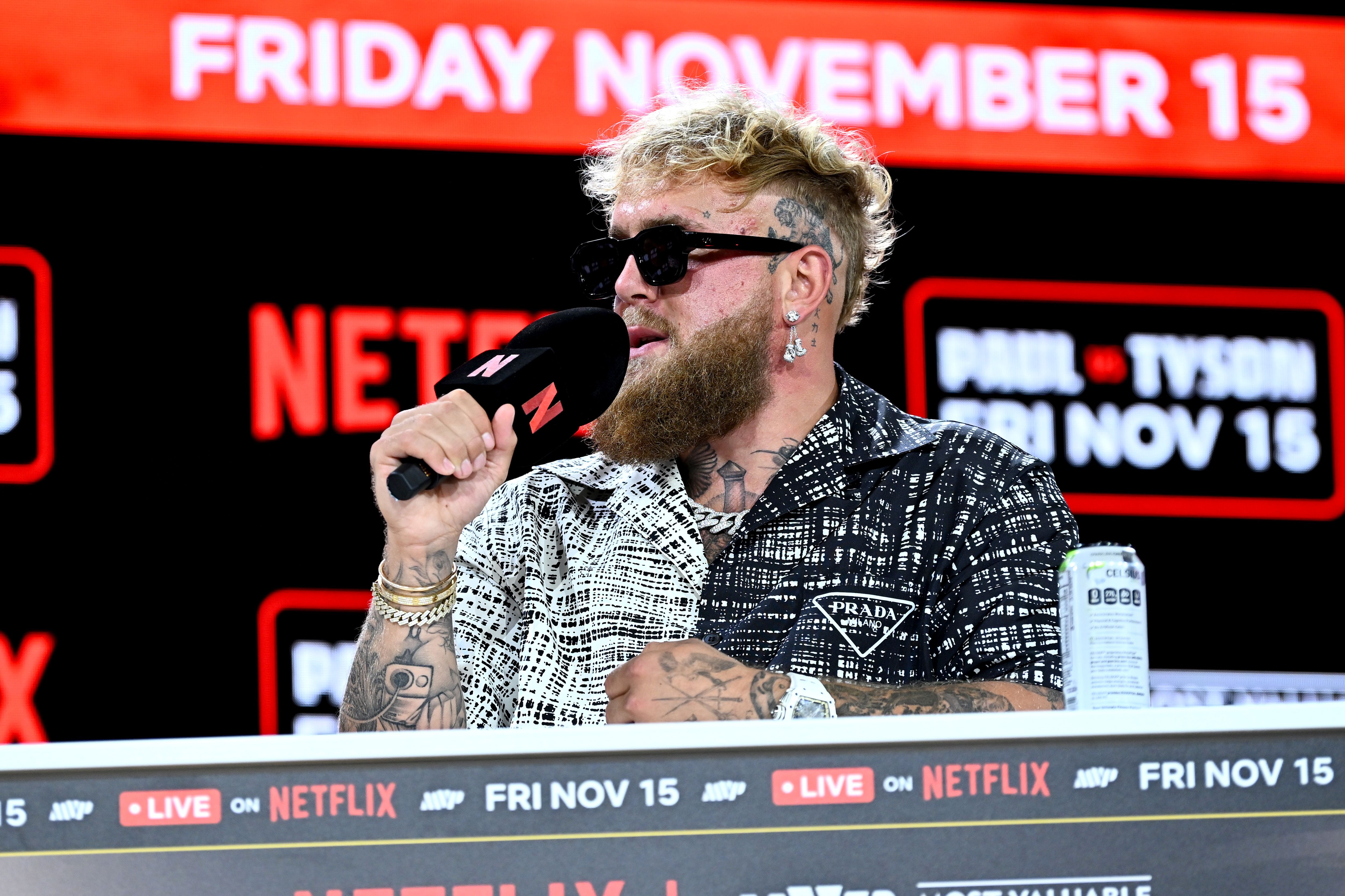 Mike Tyson and Jake Paul (R) face off